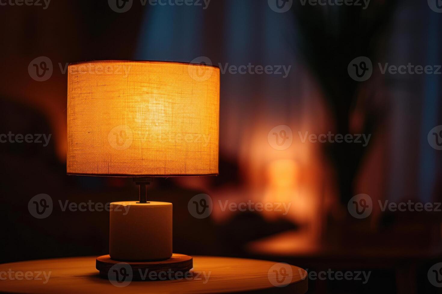 Warm glow of a table lamp illuminating a cozy room in the evening photo