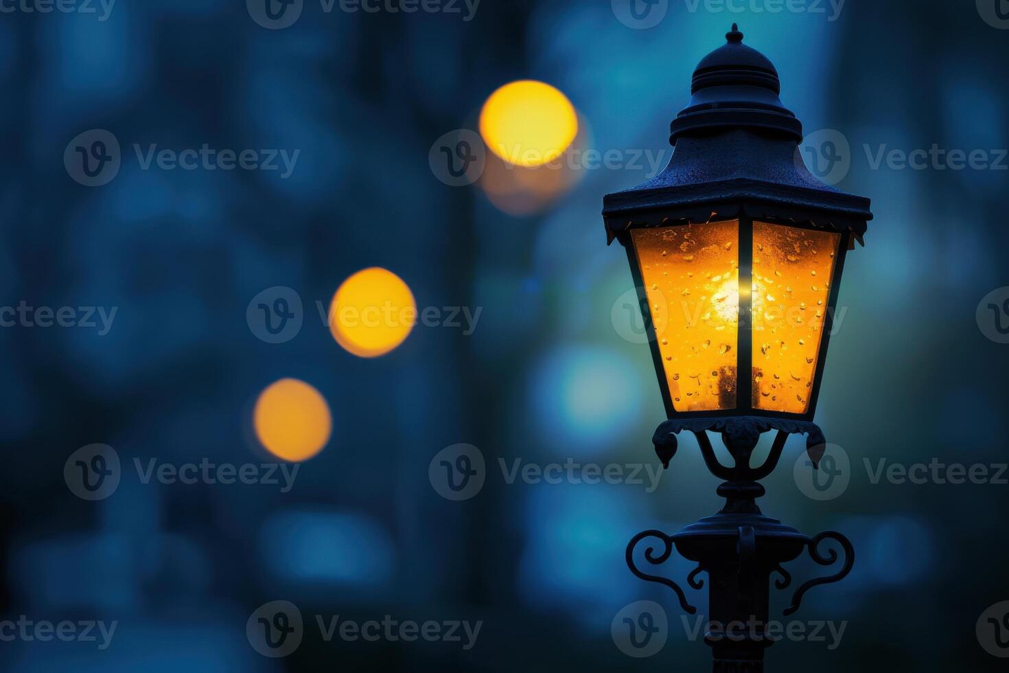 Illuminated street lamp in a rainy evening with blurred bokeh lights in the background photo