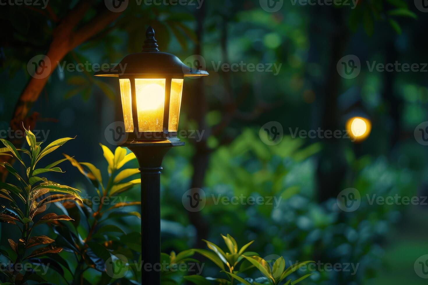 Softly glowing lanterns illuminate a serene garden path at dusk photo