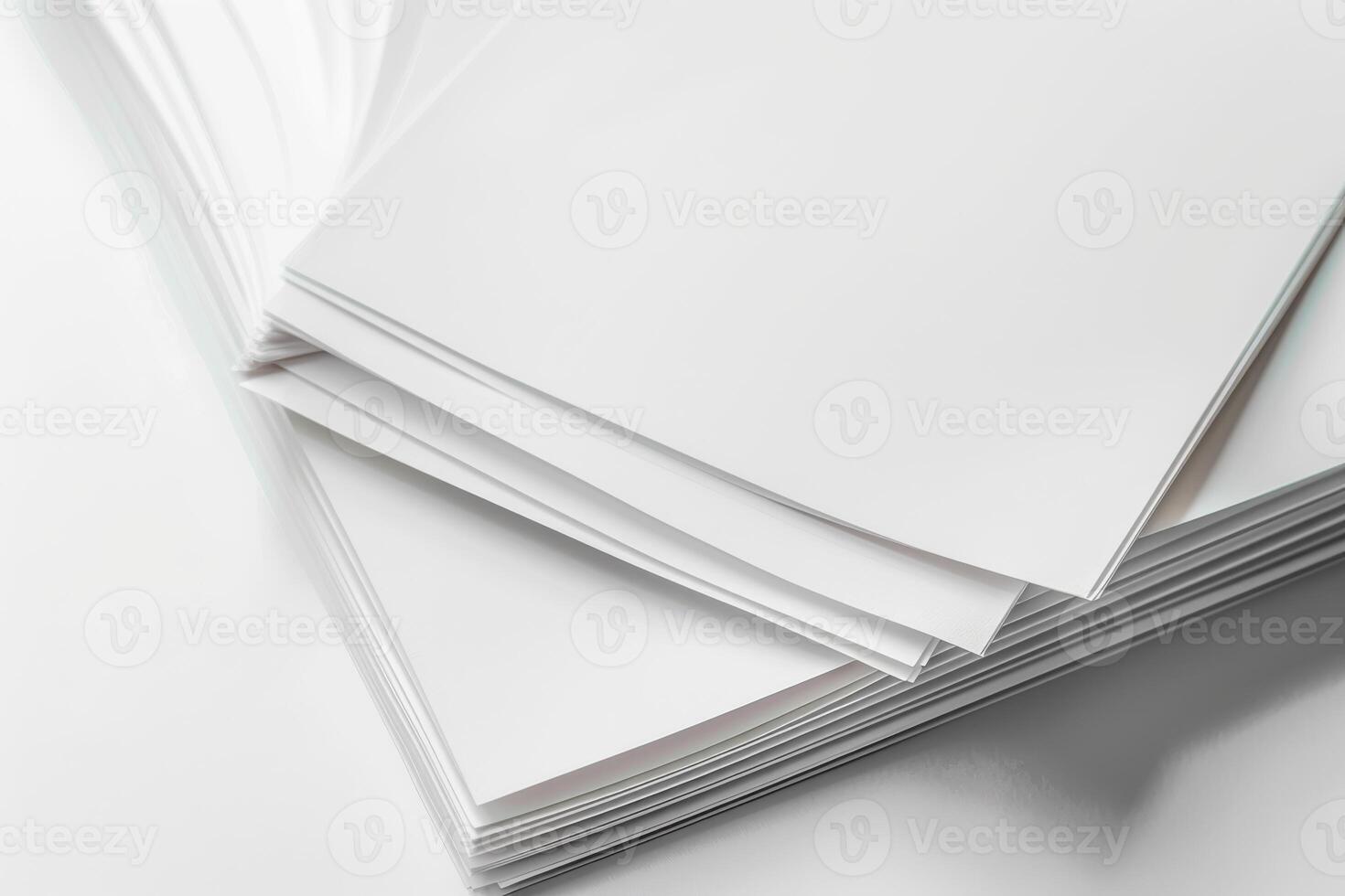 A stack of blank sheets of paper resting on a smooth surface indoors during daylight photo