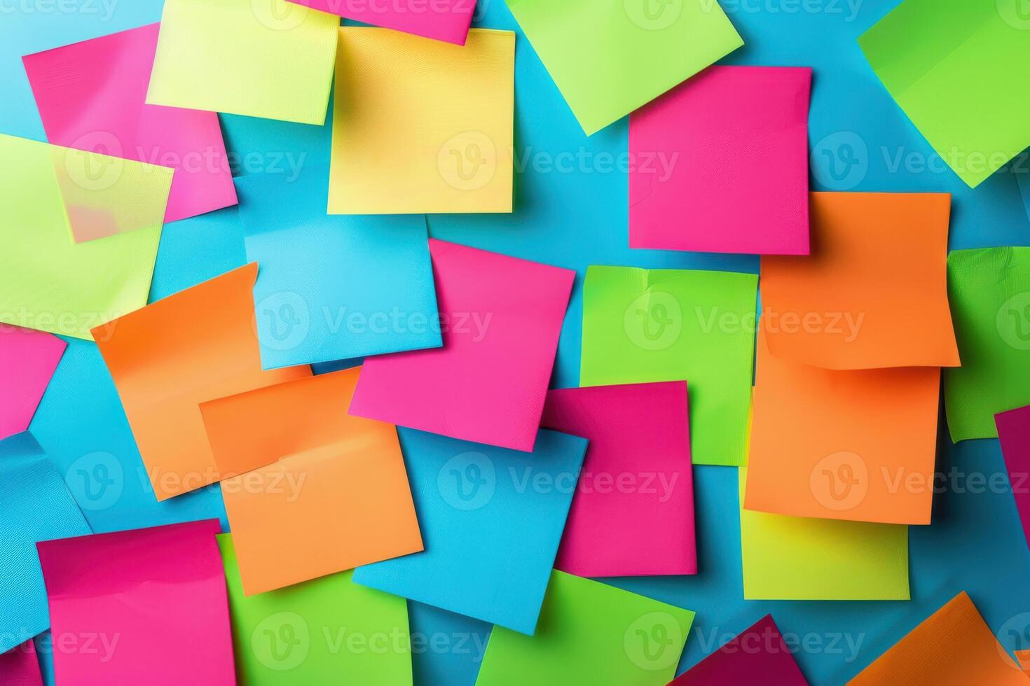 Colorful assortment of sticky notes on a blue surface in a creative workspace photo