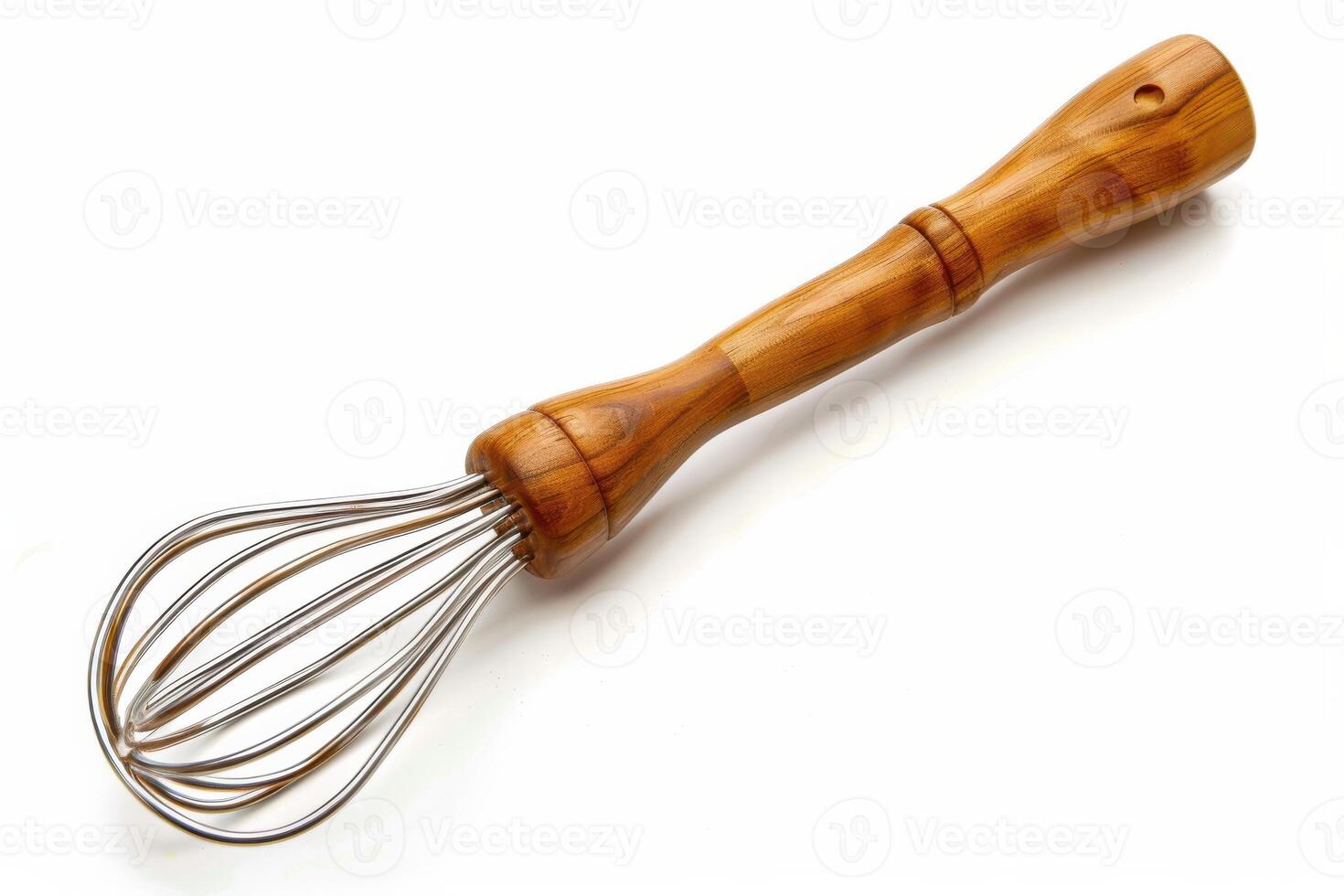 Wooden-handled whisk resting on a white background ready for mixing cooking ingredients photo