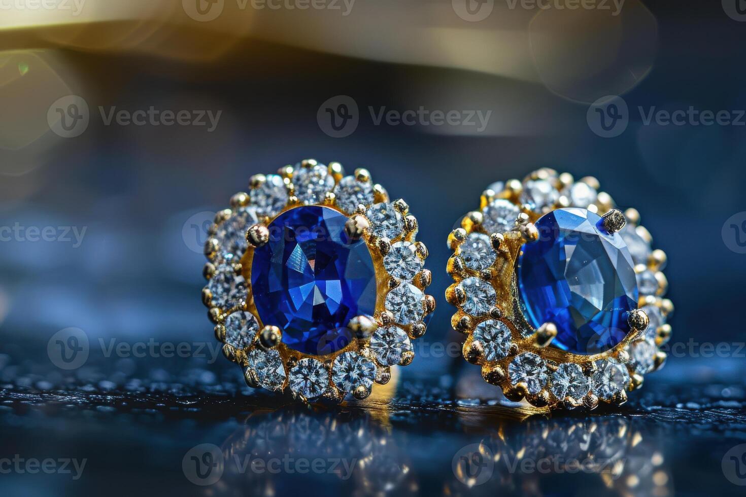 Elegant gold earrings adorned with sapphires and diamonds displayed on a reflective surface photo
