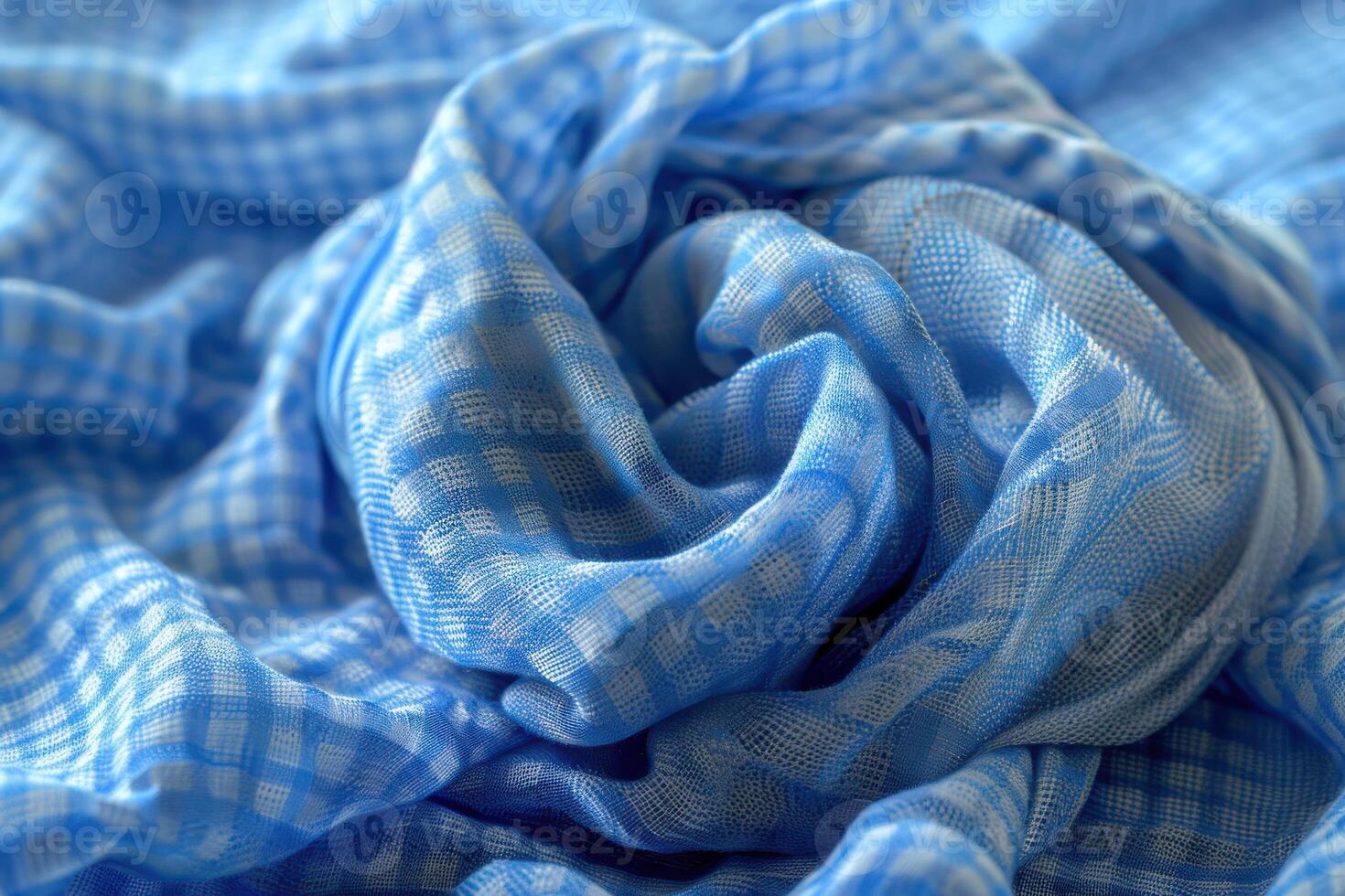 Soft blue checked fabric draped elegantly on a surface in natural light photo