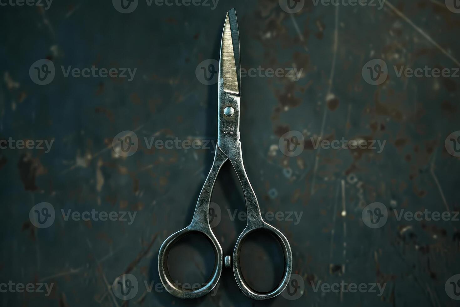Vintage scissors placed against a rustic dark background, showcasing worn metal and classic design details photo