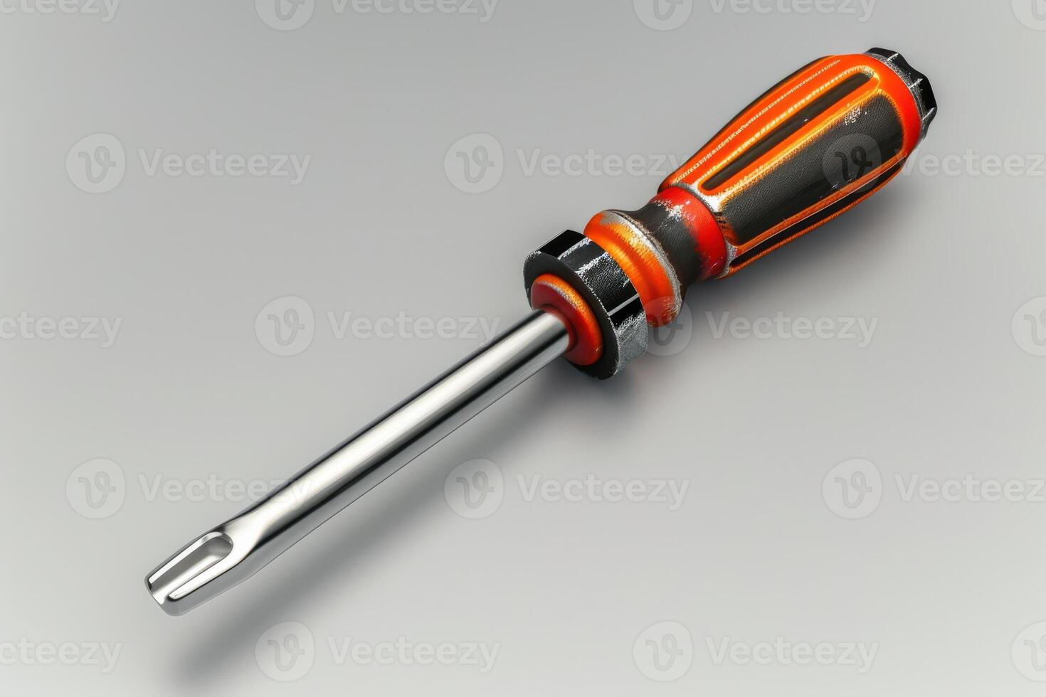 A close-up view of a flathead screwdriver with a vibrant orange and black handle resting on a neutral background photo