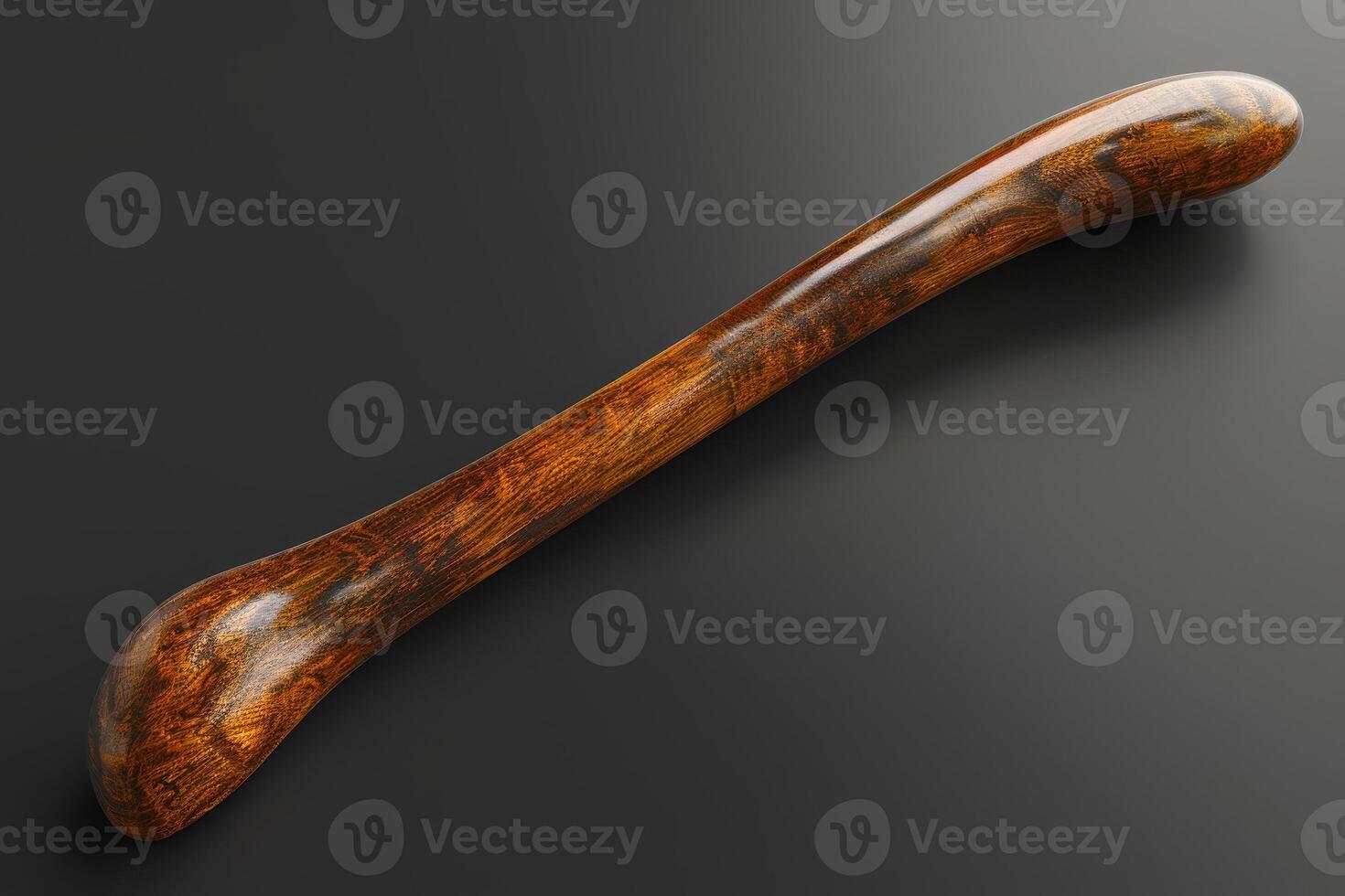 Wooden tool with a smooth finish lying on a dark surface photo