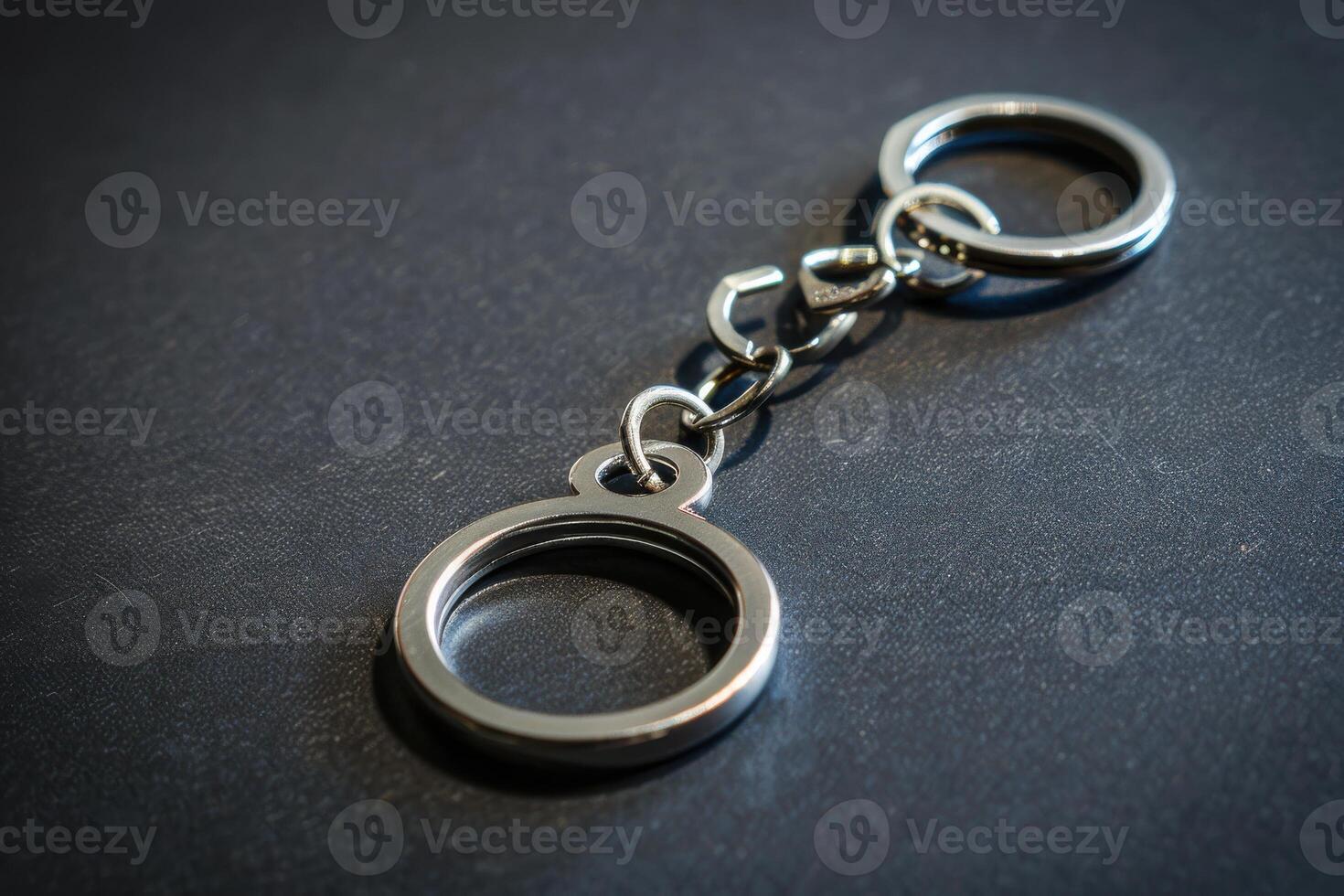 A simple metal keychain with a circular loop on a dark surface showcasing its sleek design and functionality photo