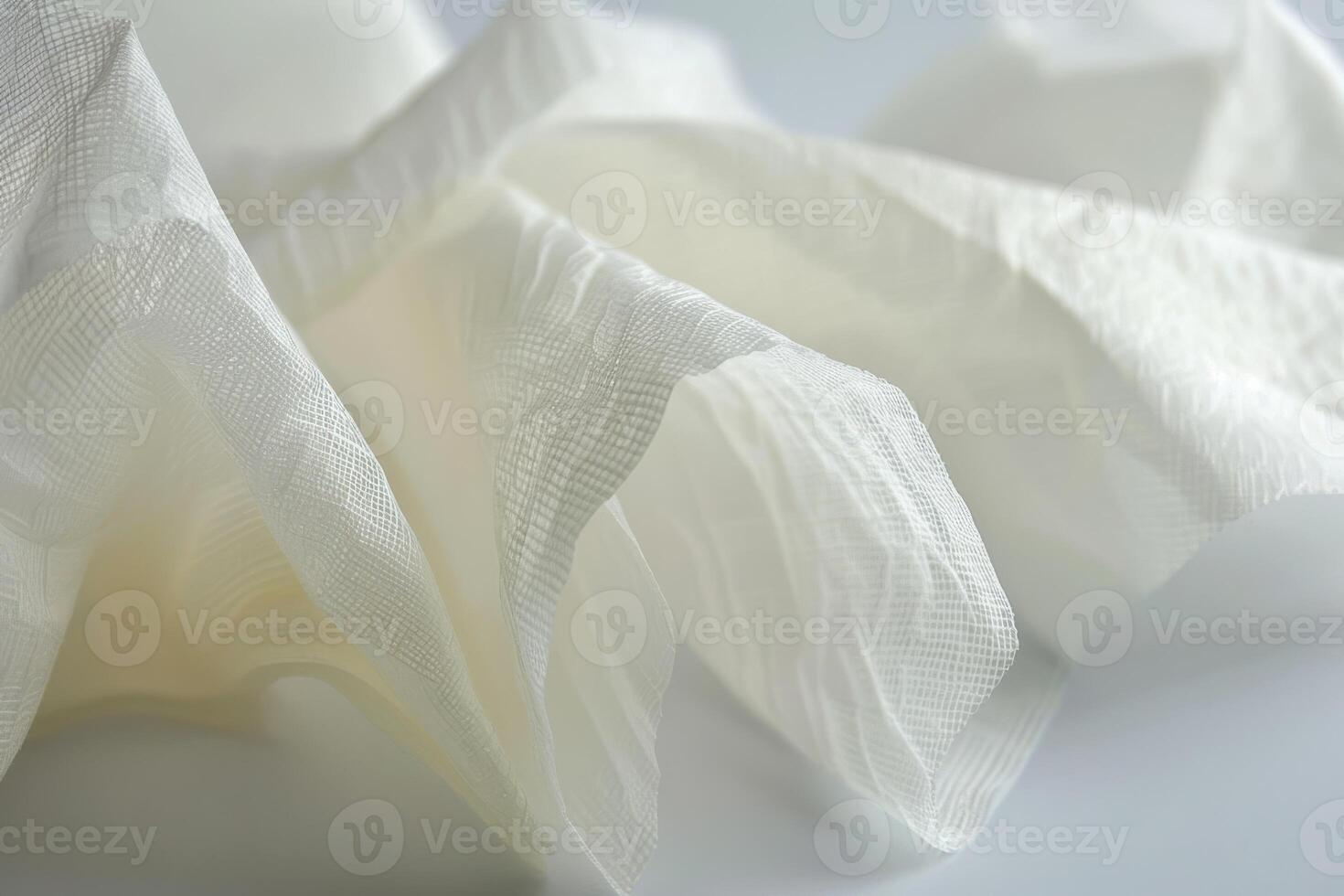 Close-up of crumpled white fabric on a smooth surface photo