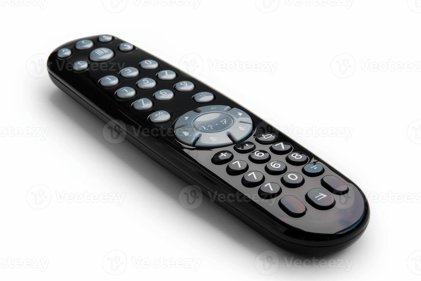 A sleek black remote control on a white background during daylight photo