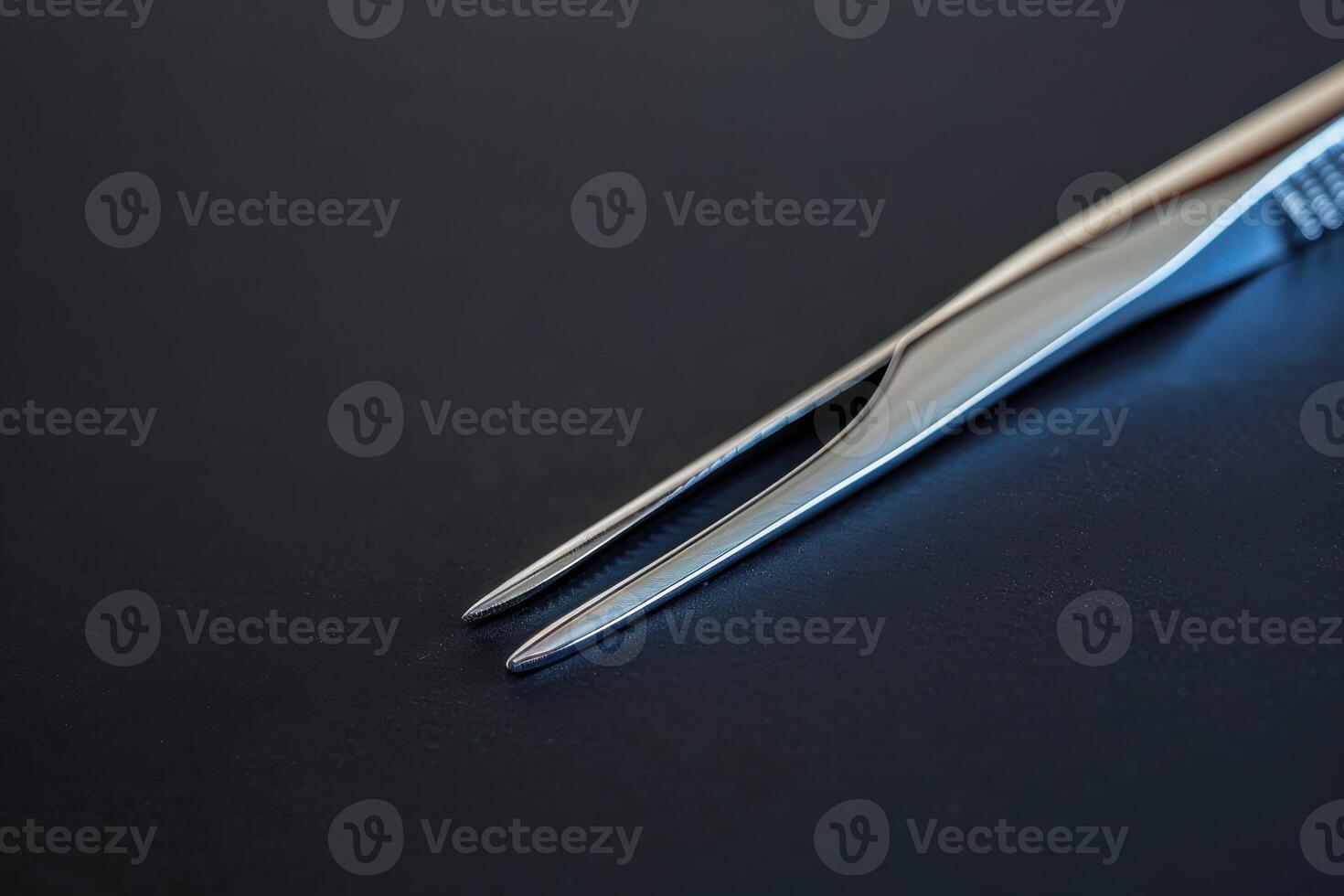 Precision scissors on a dark surface showcasing sharp tips and sleek design photo