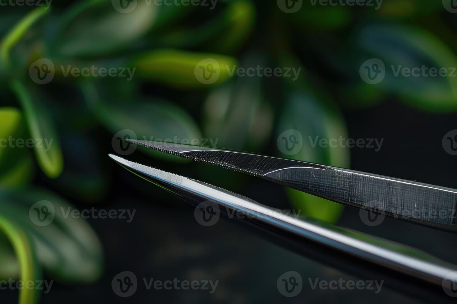 Close-up of sharp scissors against a backdrop of green foliage photo