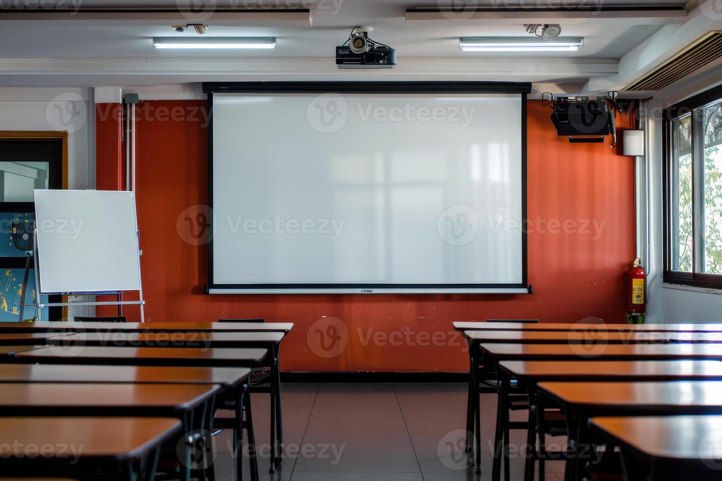 Classroom setting with empty desks and a projector screen in a well-lit learning space photo