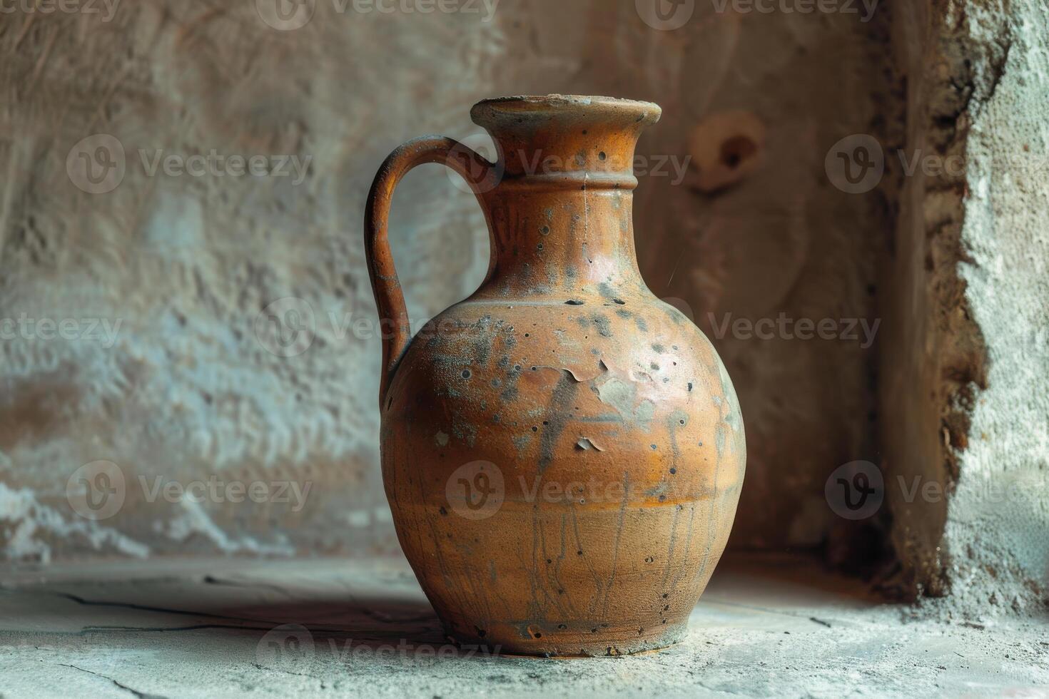 Ancient clay jug resting on a stone surface in a rustic interior setting photo