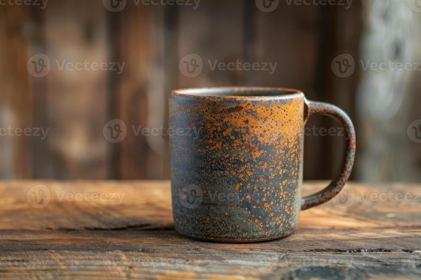 Rustic ceramic mug resting on weathered wooden table in cozy indoor setting photo