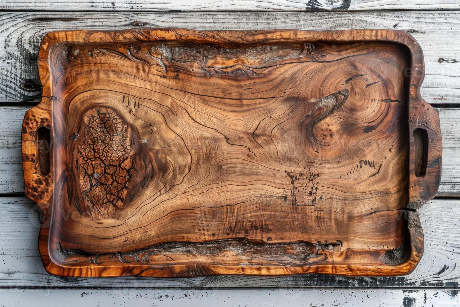 Elegant handcrafted wooden serving tray with unique grain patterns on a rustic wooden table photo