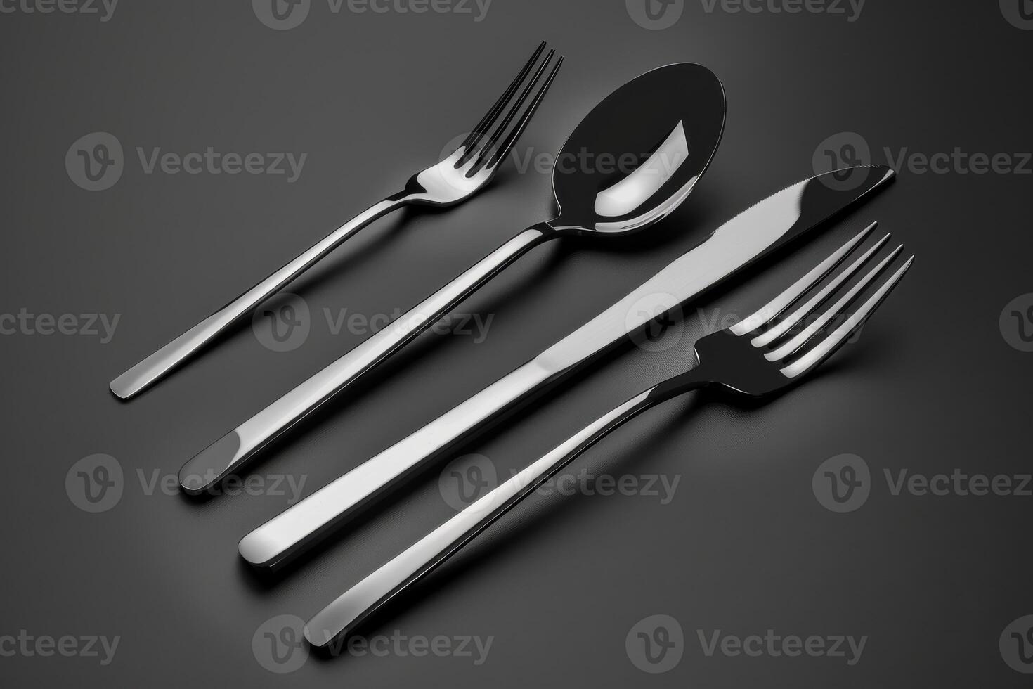 Elegant stainless steel cutlery set arranged neatly on a dark background for dining purposes photo