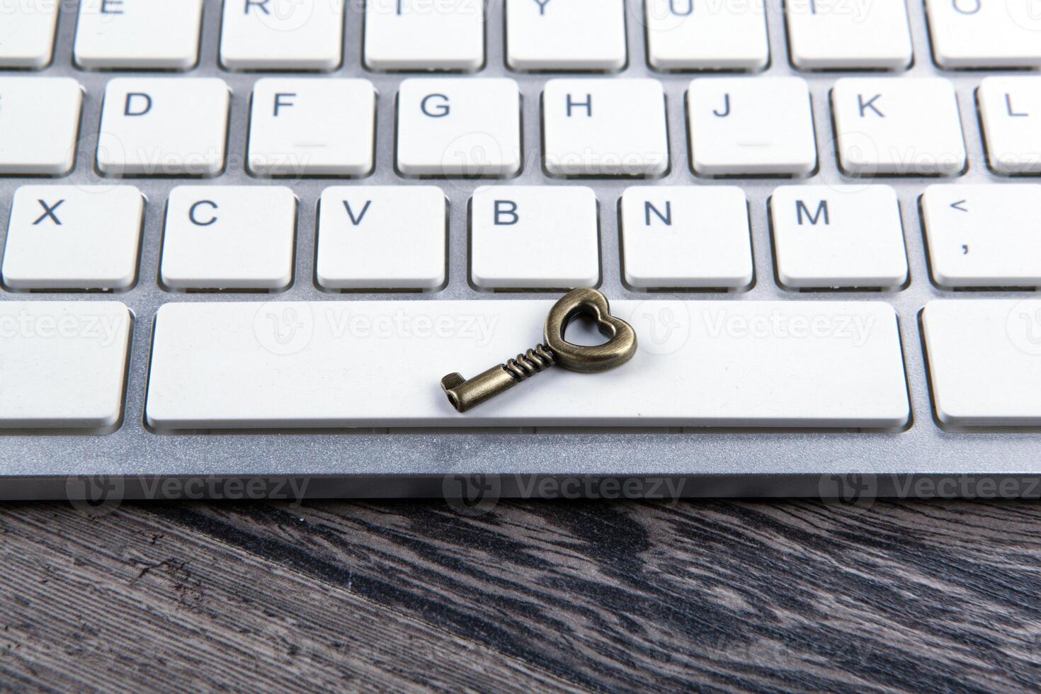 little key on computer keyboard as concept protection closeup photo