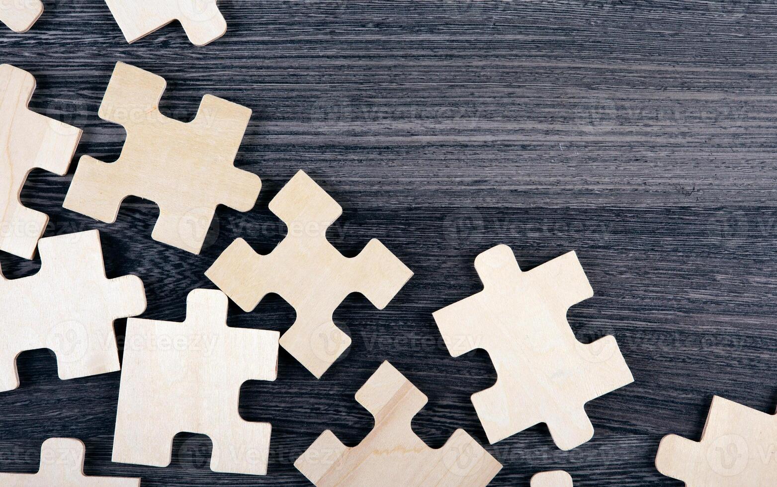 puzzle elements on a wooden background as a riddle photo