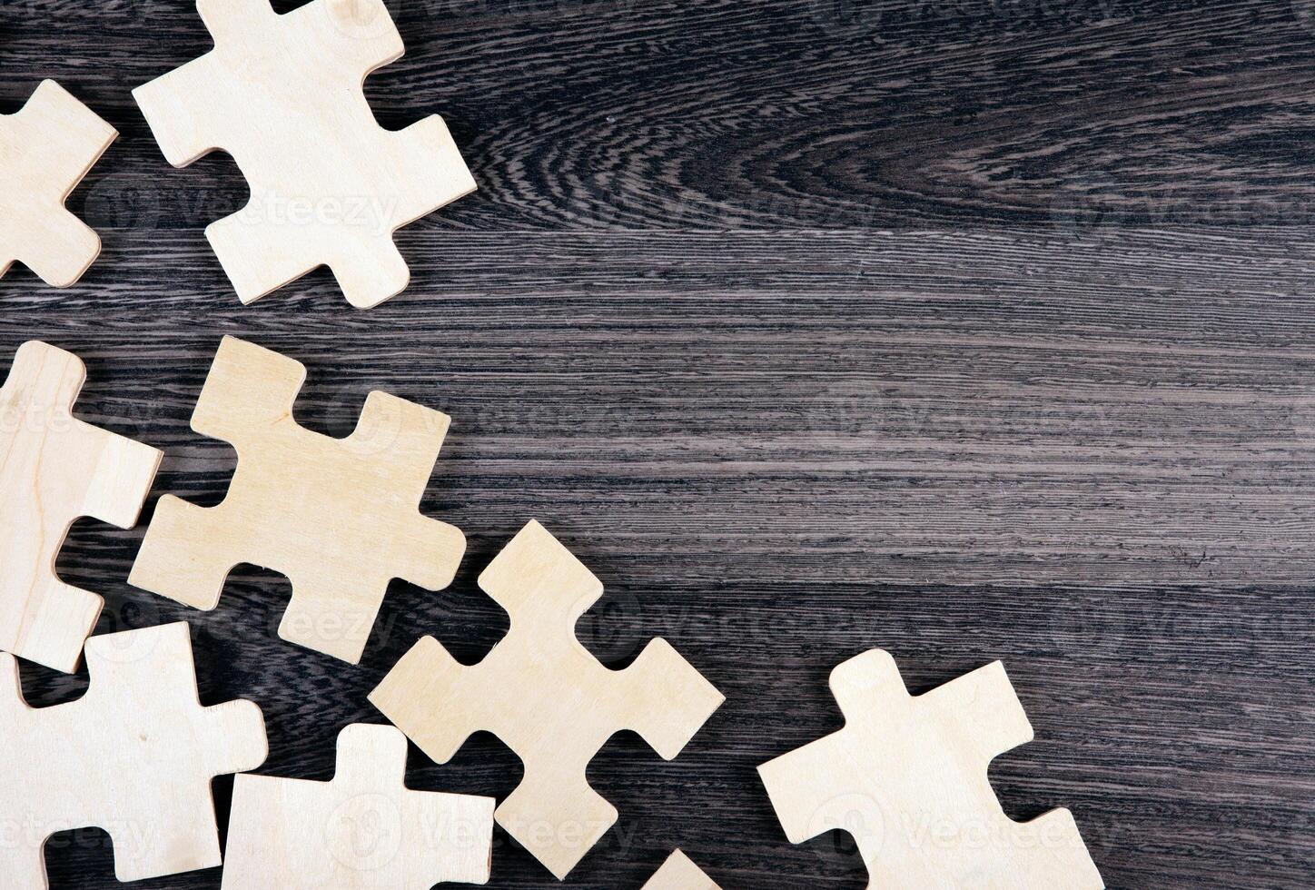 puzzle elements on a wooden background as a riddle photo