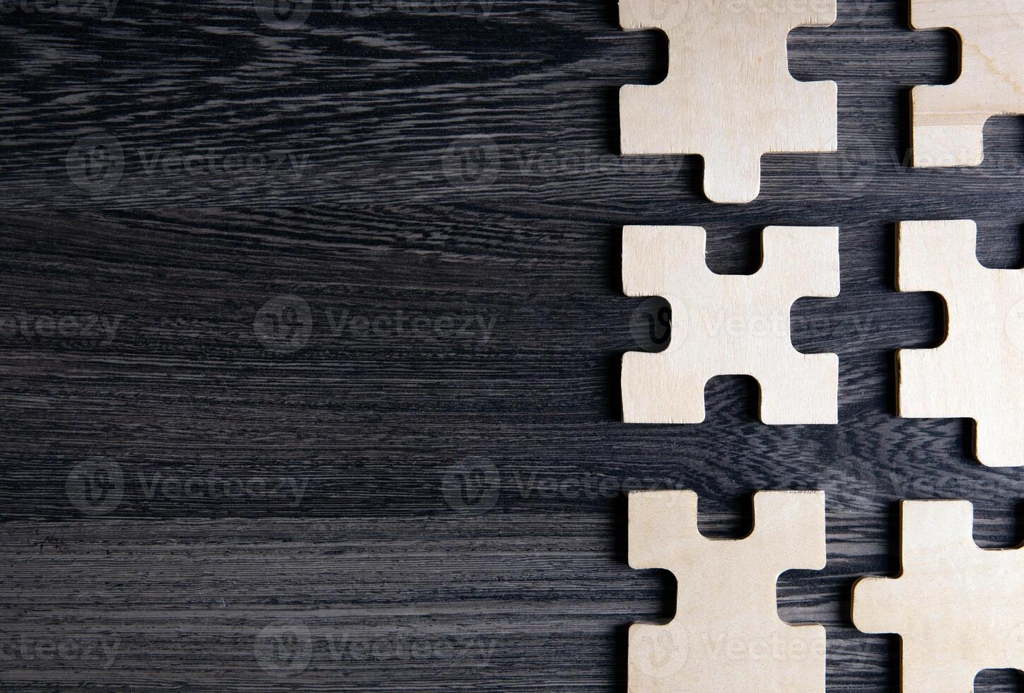 puzzle elements on a wooden background as a riddle photo