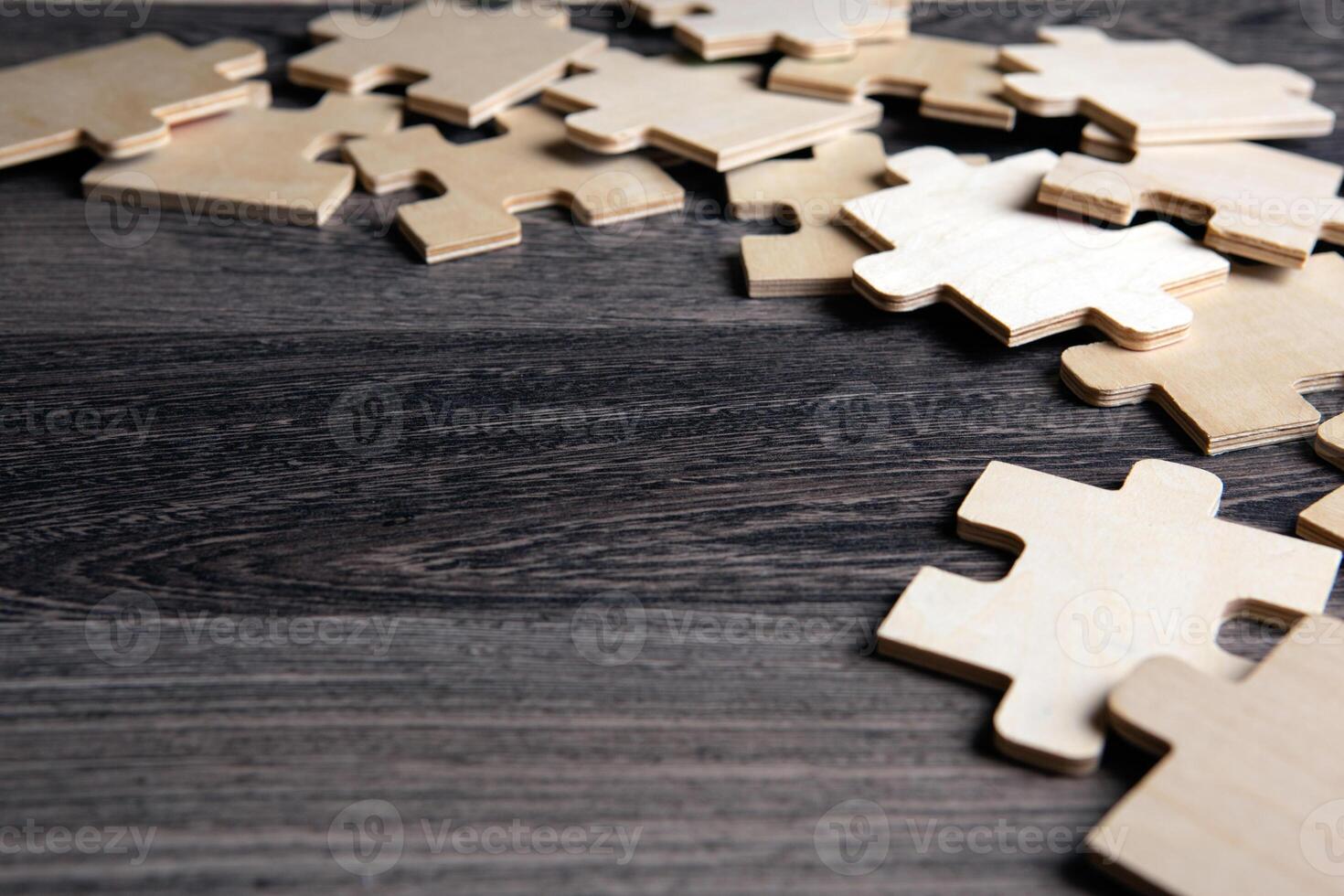 puzzle elements on a wooden background as a riddle photo