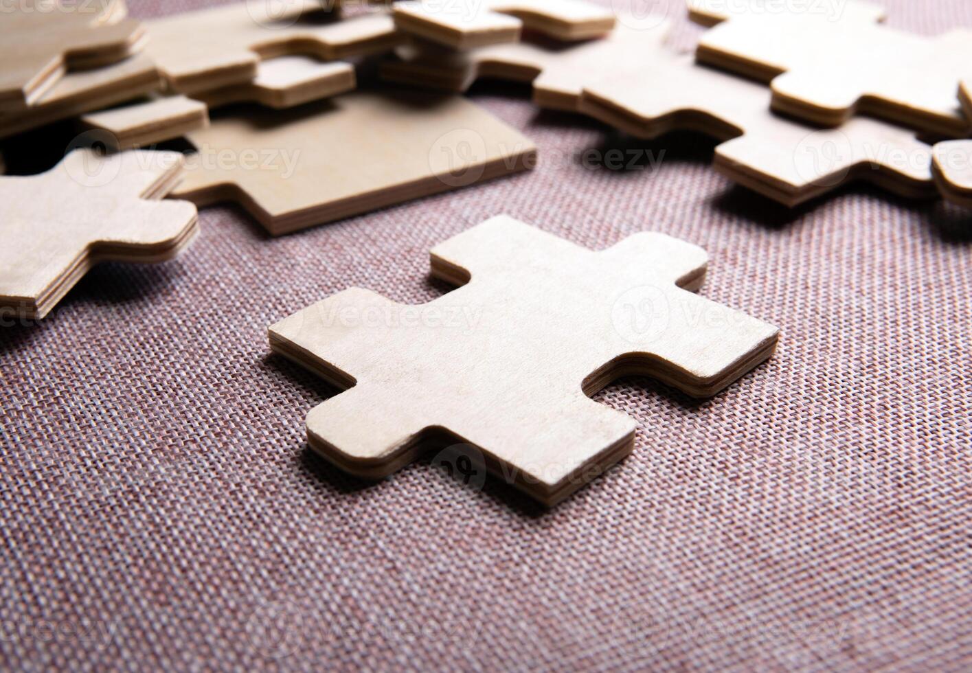 puzzle elements on a texile background as a riddle photo
