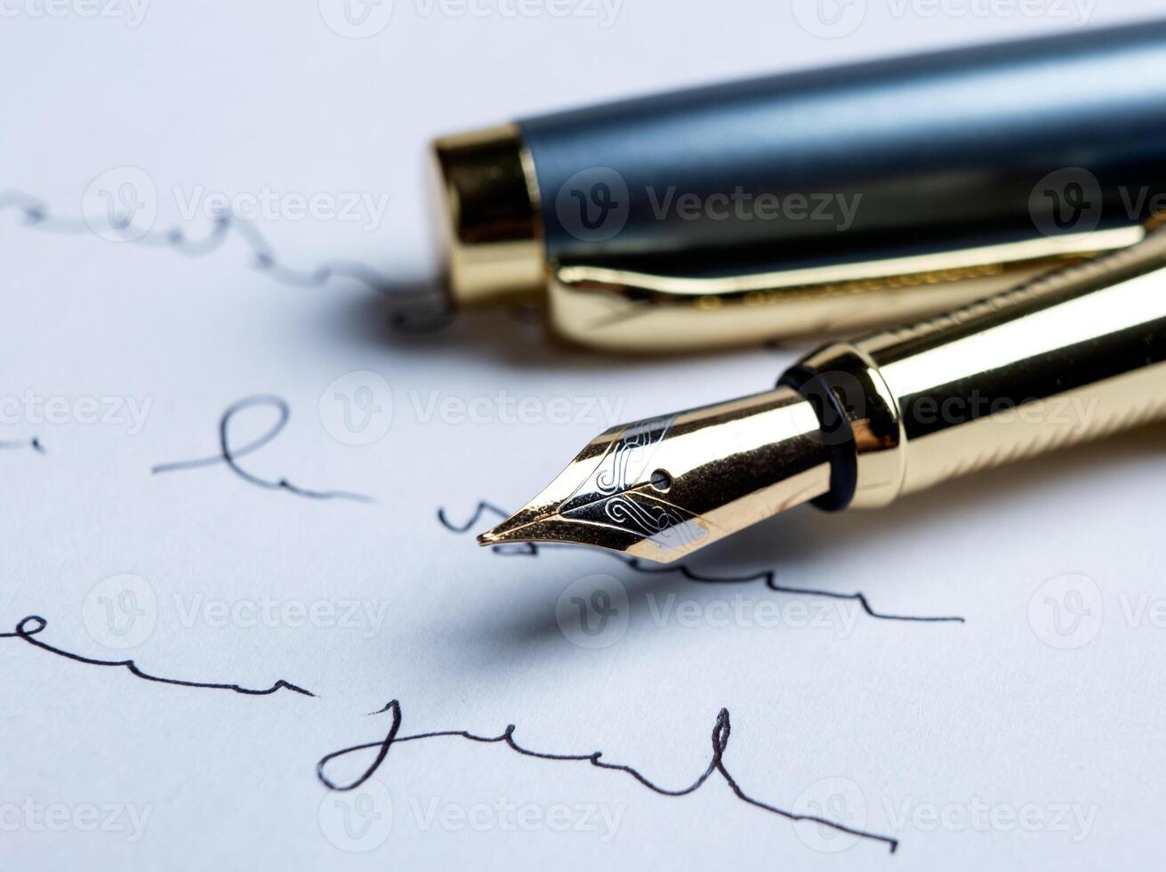 fountain pen on paper with ink text on the paper photo