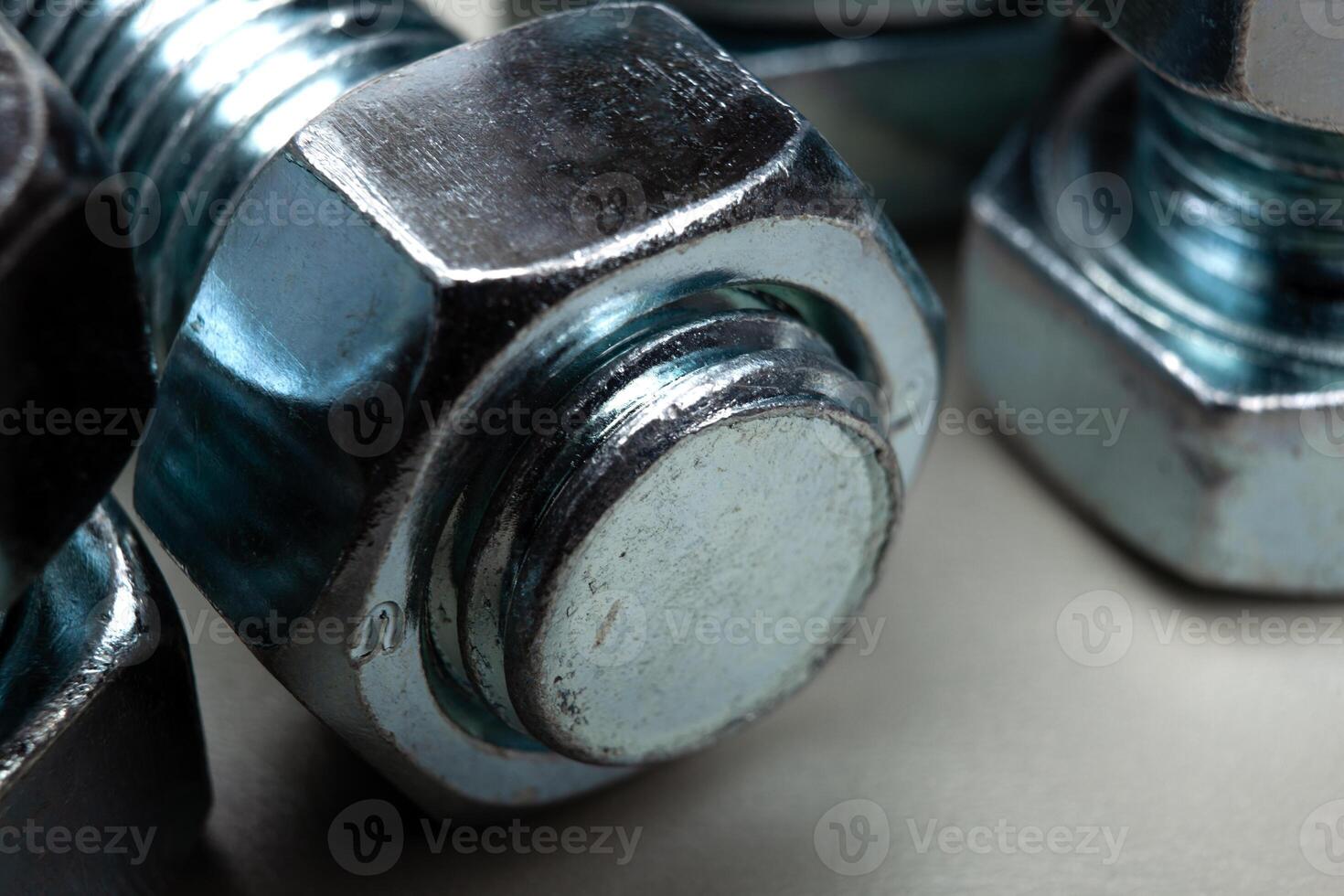 steel nuts, screwed on a bolt closeup photo
