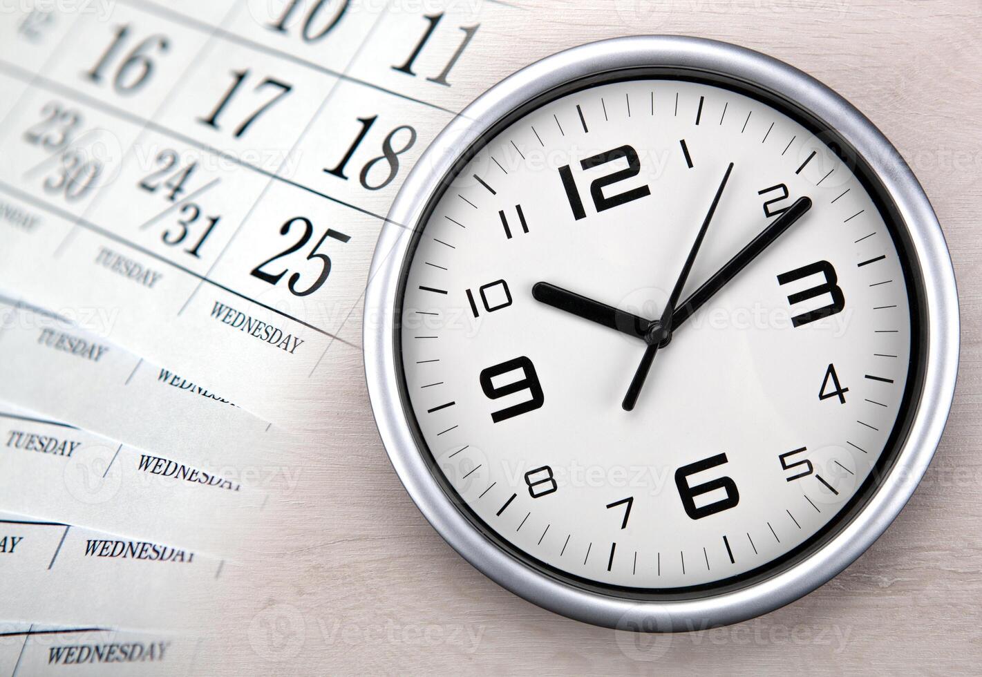 large white clock face with calendar sheets photo