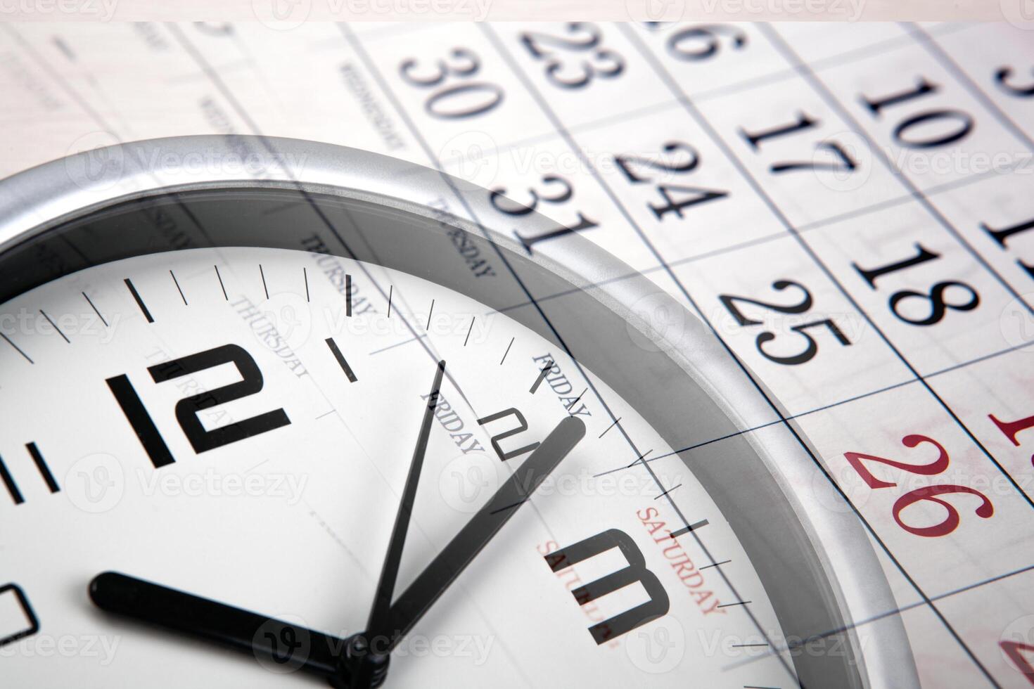 large white clock face with calendar sheets photo