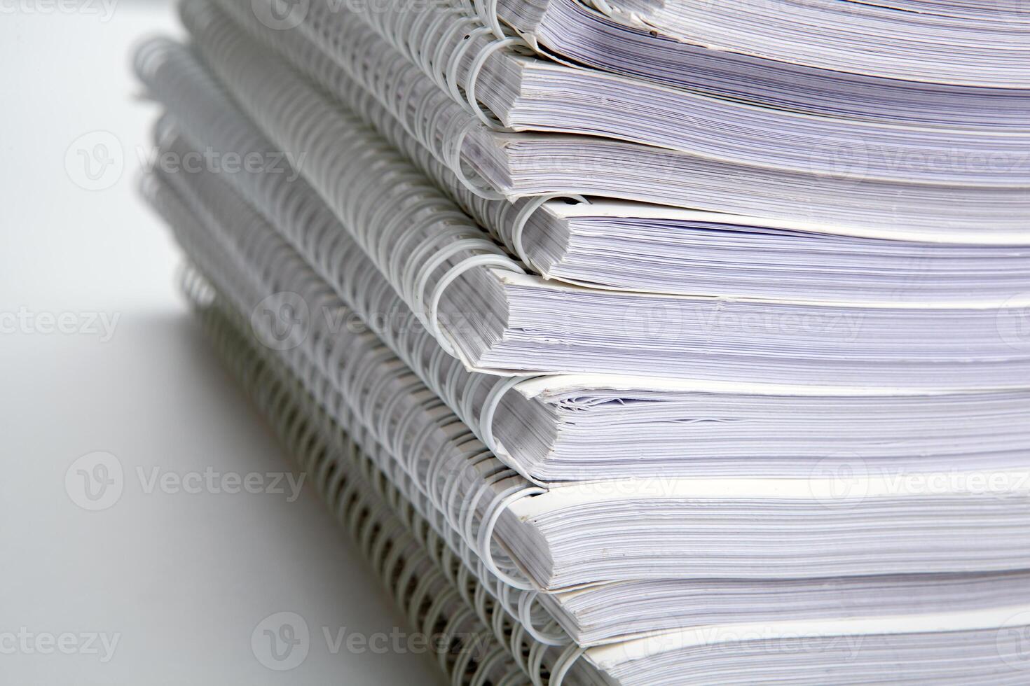 stack of large white notebooks on the desktop concept photo