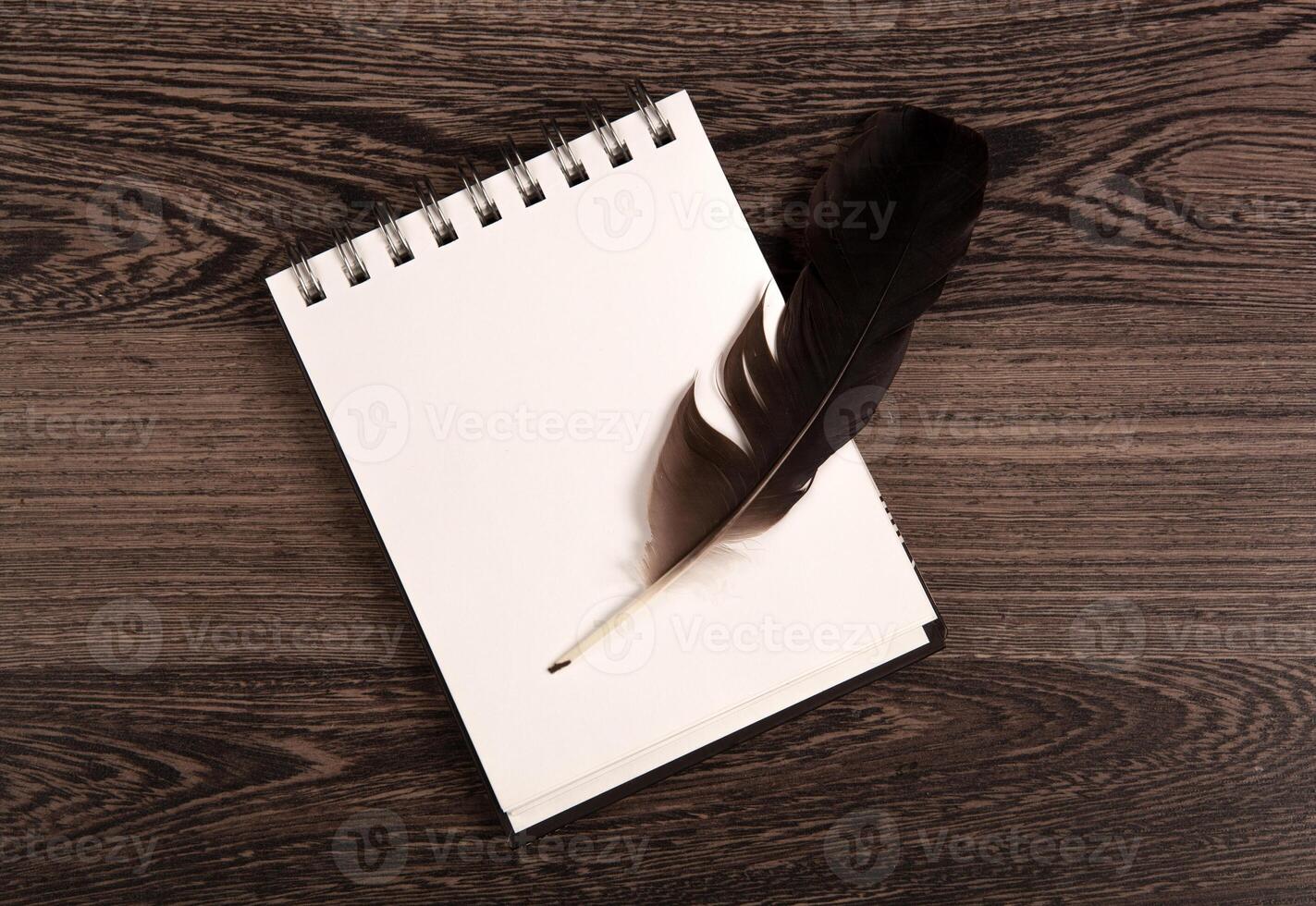 writing pen and notebook on a wooden table photo