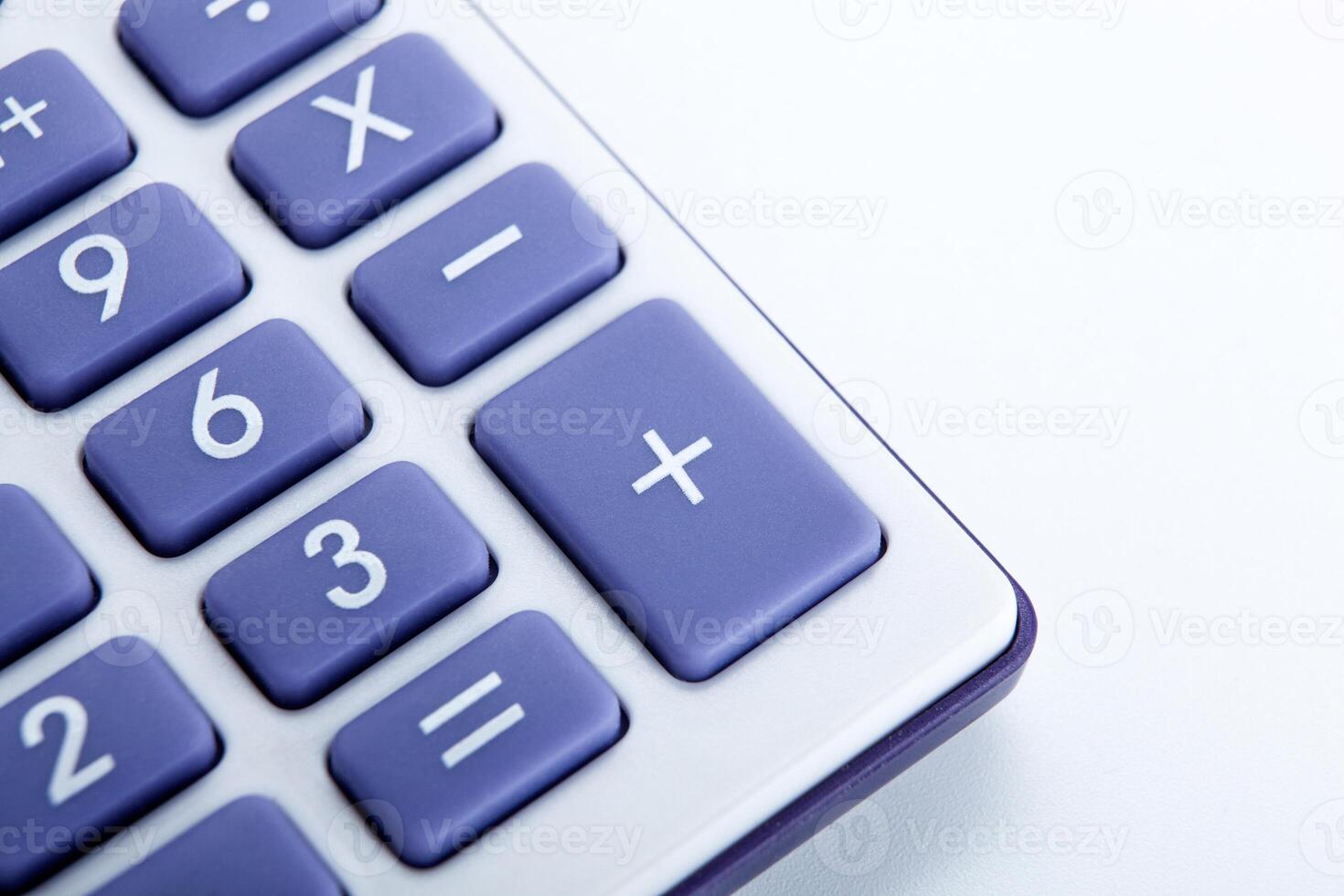 calculator with blue buttons on a white background photo