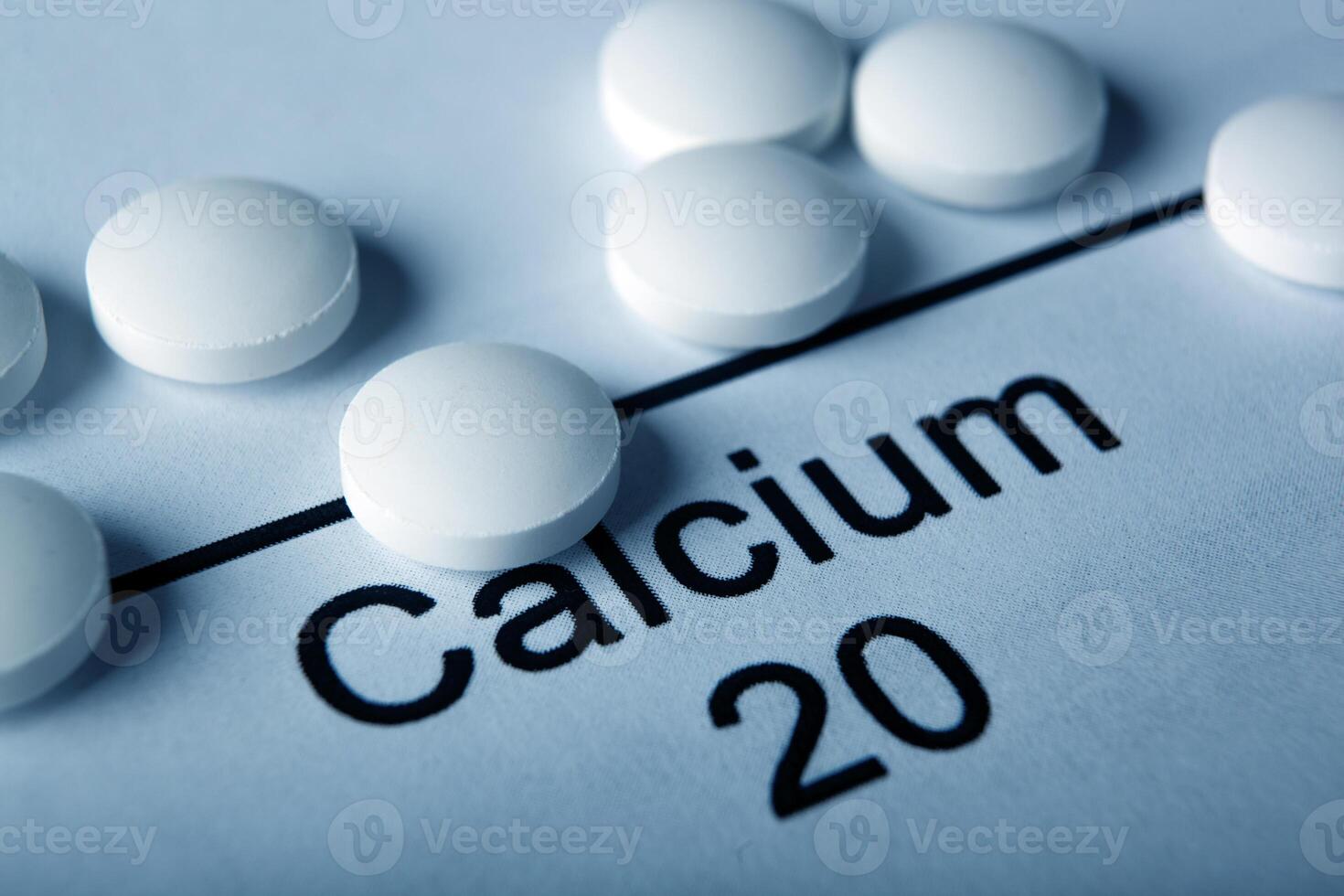 white tablets with calcium and the inscription of the chemical element Calcium photo