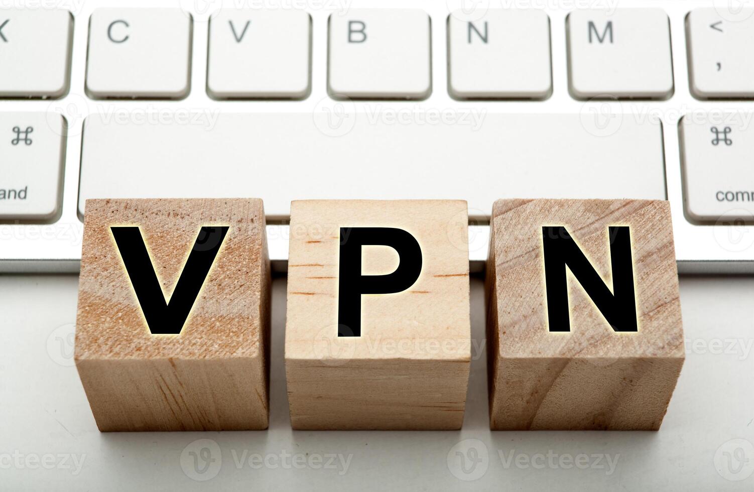 three wooden cubes with inscription VPN with the computer keyboard photo