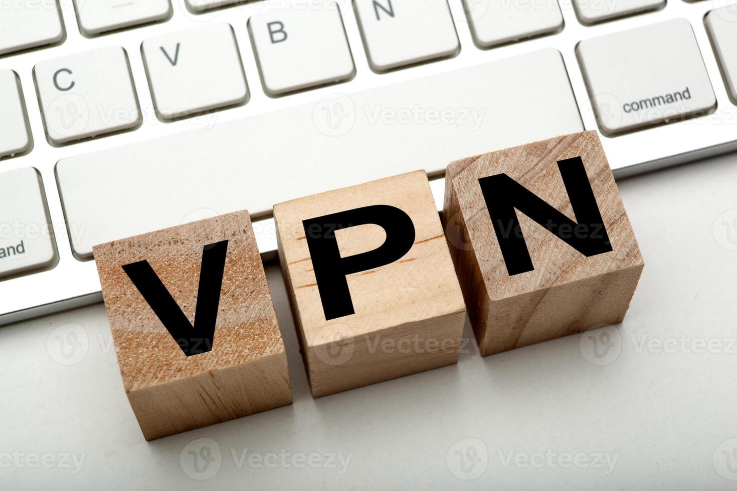 three wooden cubes with inscription VPN with the computer keyboard photo