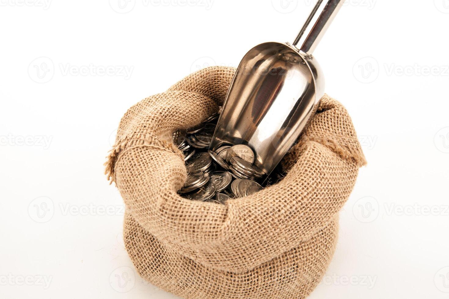 Russian ruble coins in a bag with metal scoop on a white background photo