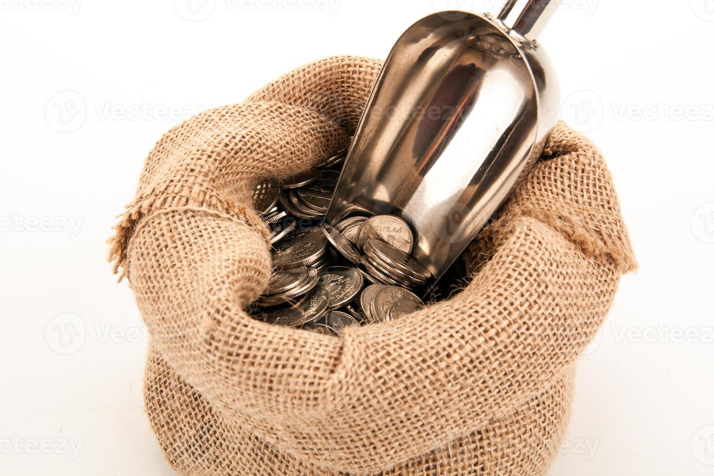 Russian ruble coins in a bag with metal scoop on a white background photo