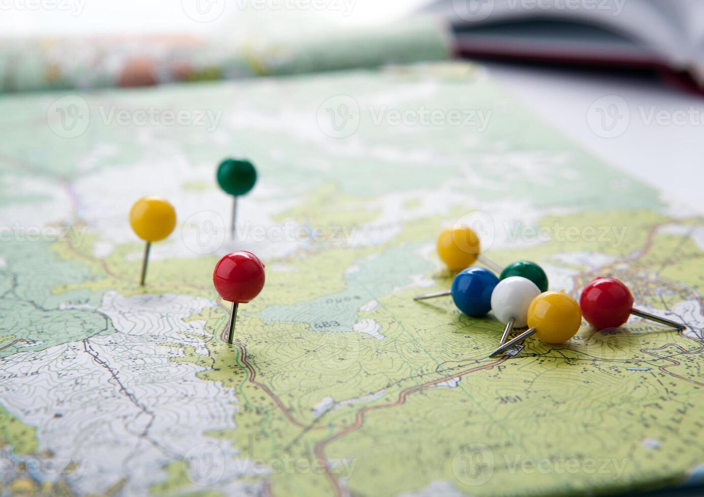 topographic map with colored needles pushpins close up photo