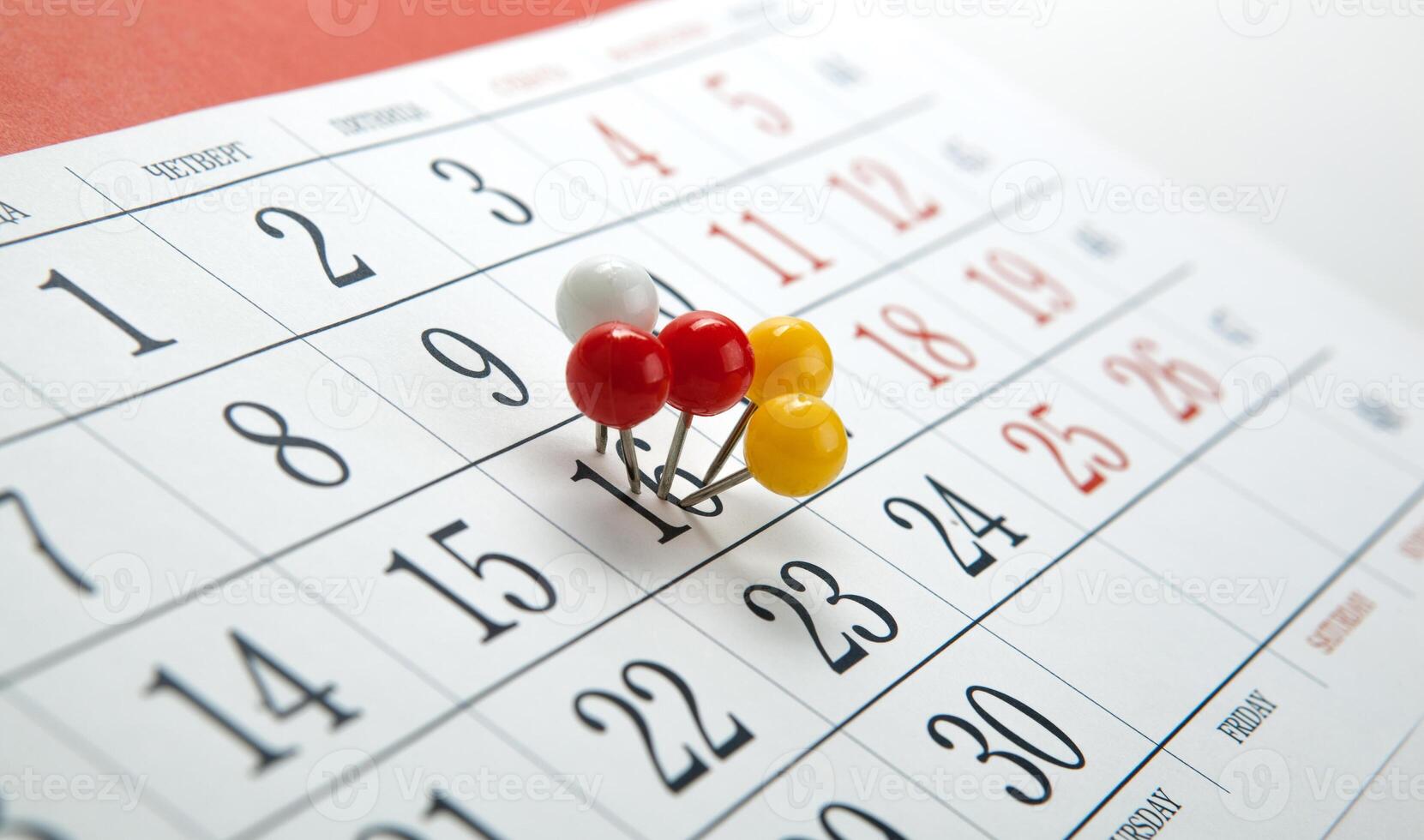 wall calendar with number of days colored needles photo