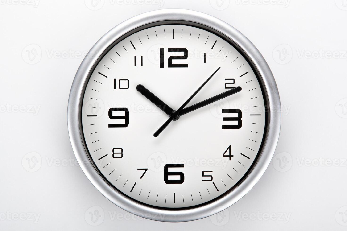 white clock face with black digits on a gray background closeup photo