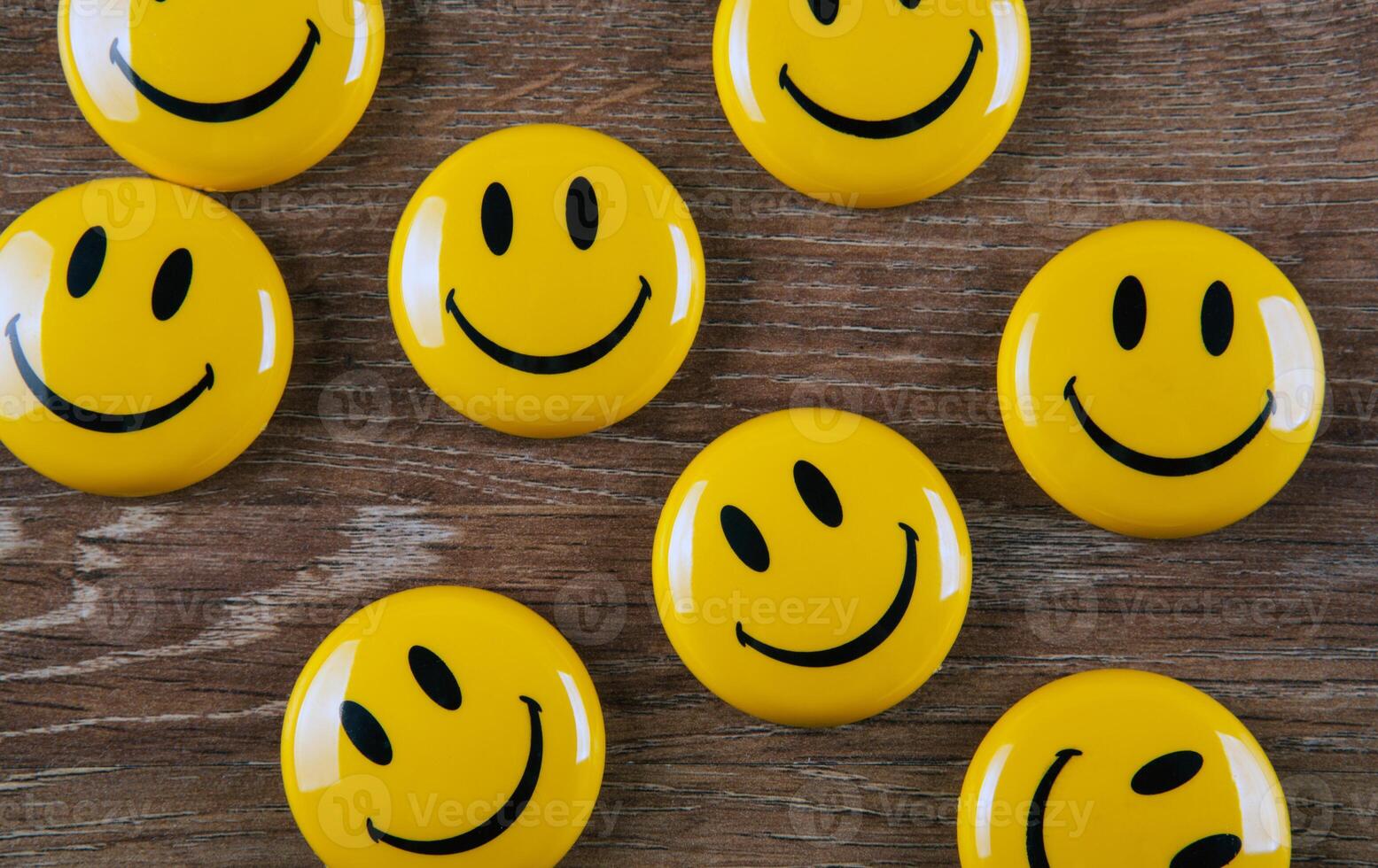 yellow emoticon icons on wooden background top view photo
