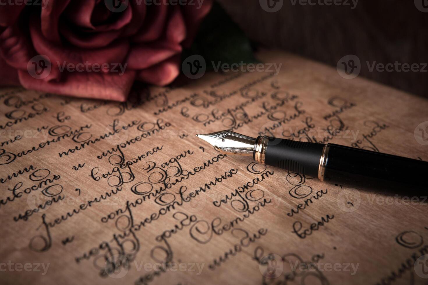 fountain pen on letter with text and red rose photo