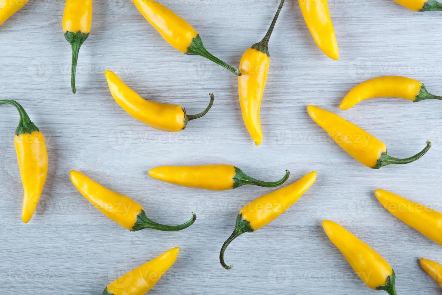 fruits of yellow fresh chilli pepper on gray background still life photo