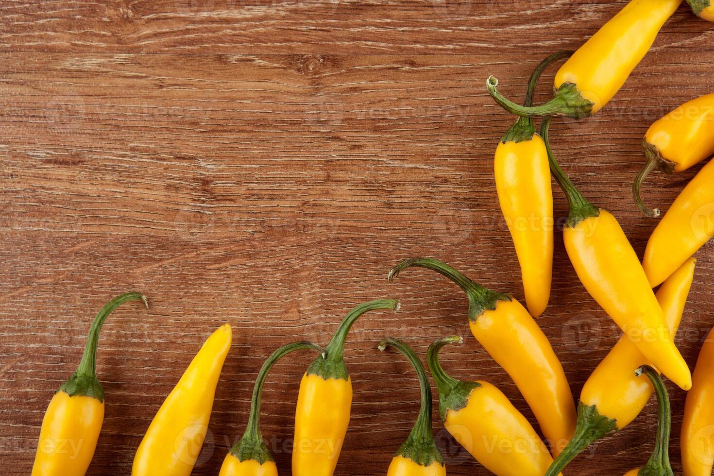 fruits of yellow fresh chilli pepper on a wooden background still life photo