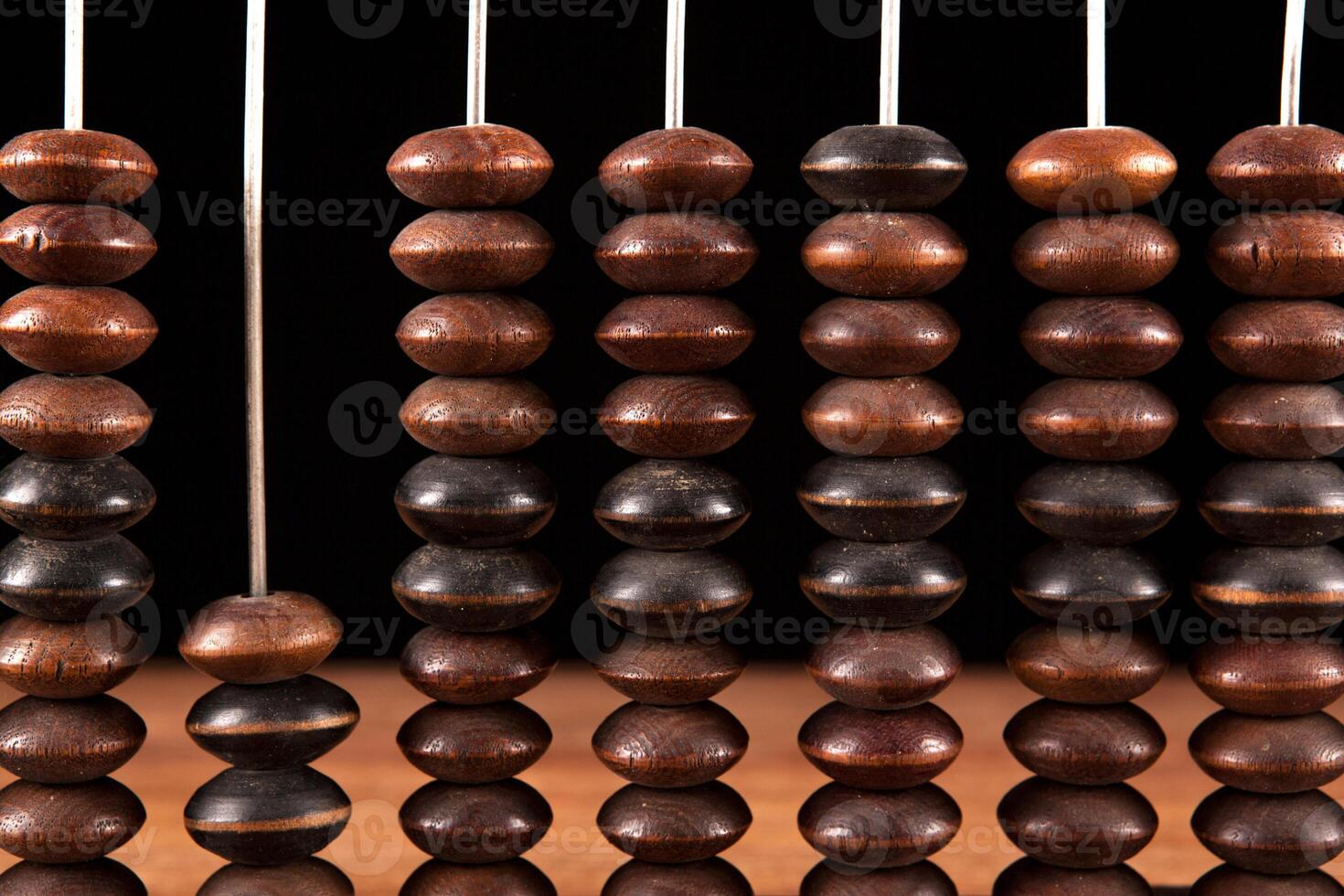 antique abacus with knuckles on a table on a black background photo
