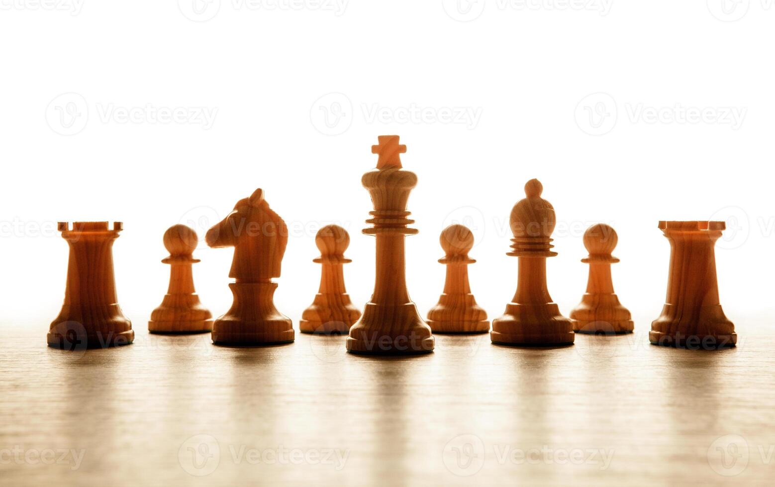 wooden white chess pieces lined up in a row photo