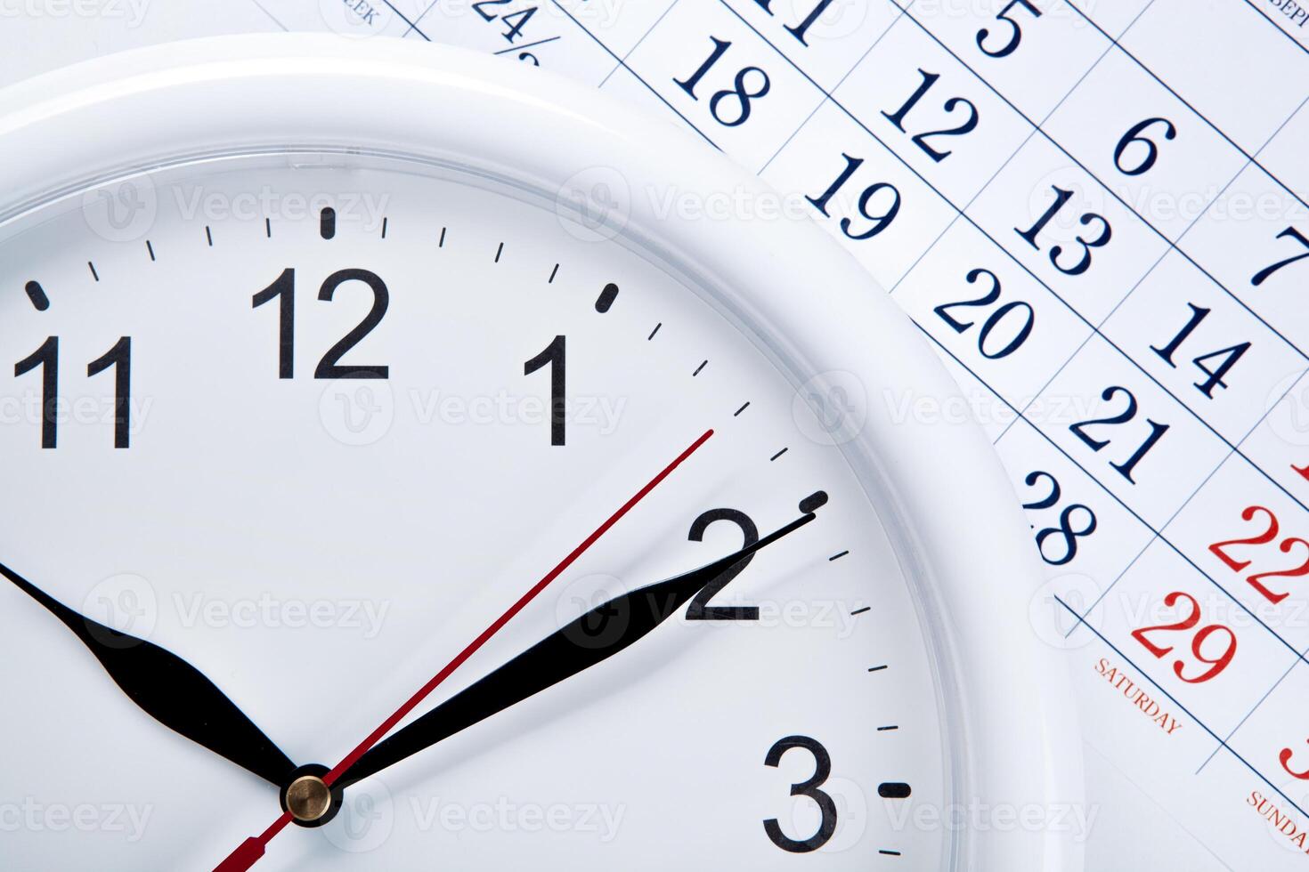 clock face and calendar sheet with numbers photo