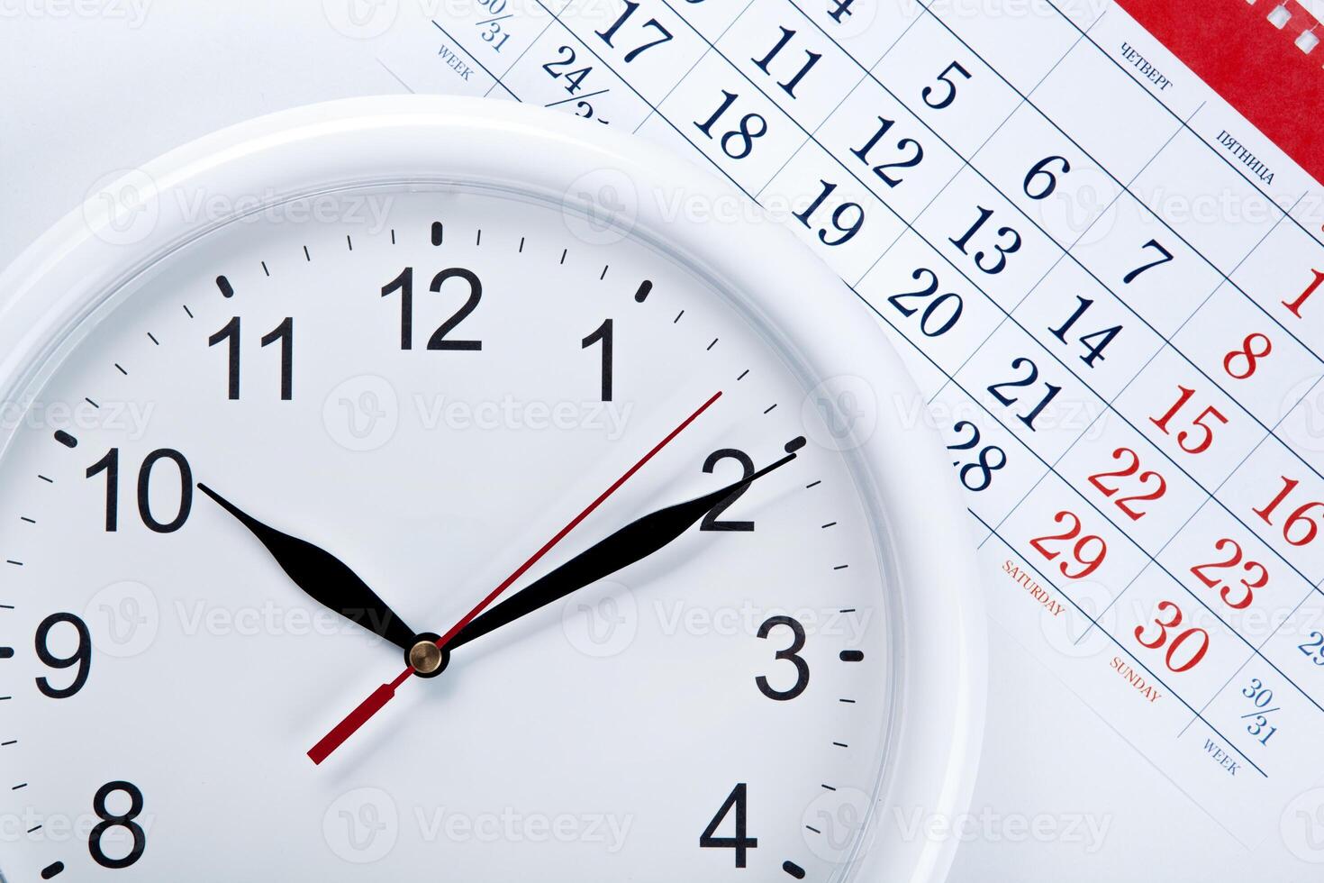 clock face and calendar sheet with numbers photo